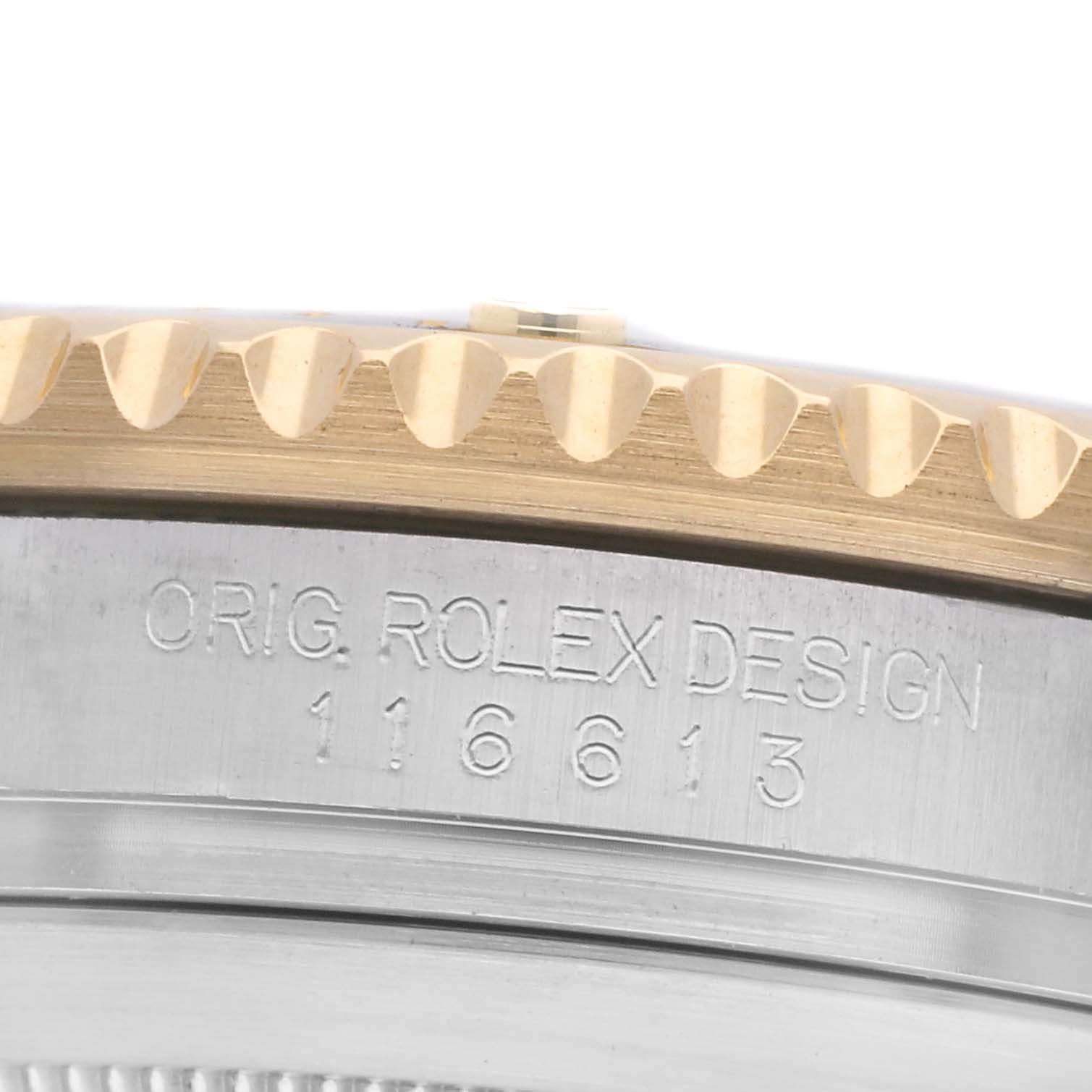 The image shows a close-up of the side of a Rolex Submariner 116613 Men
s Steel and Gold (two tone) Black Dial 116613 Men
s Steel and Gold (two tone) Black Dial watch, highlighting the bezel and engraved model number.