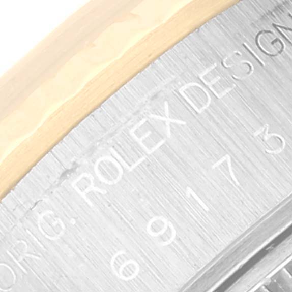 The image shows an angled close-up of the metal casing and engraved text on the Rolex Datejust 69173 Women's Steel and Gold (two tone) Blue Dial 69173 Women's Steel and Gold (two tone) Blue Dial watch.