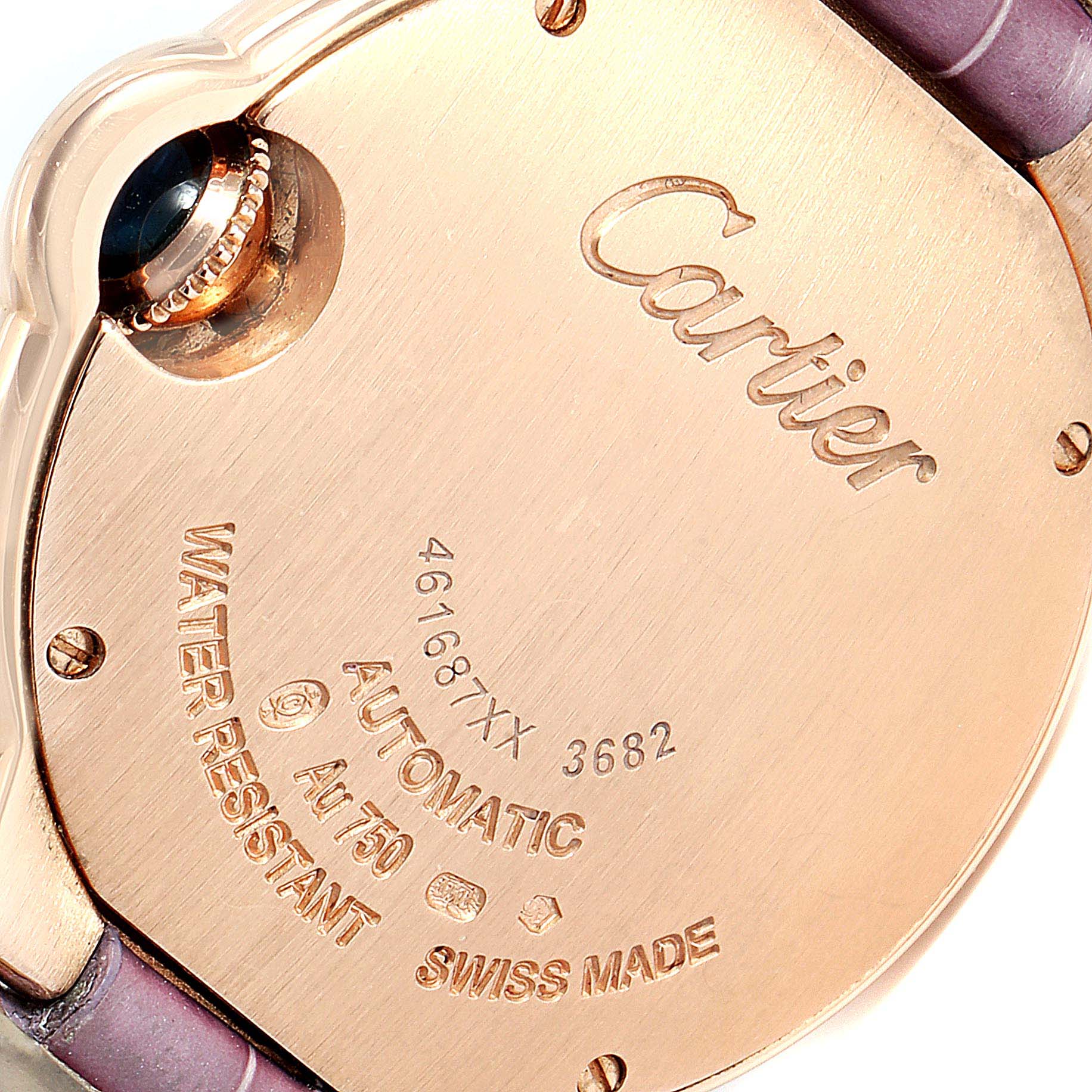 The image shows the back case and crown of a Cartier Ballon Bleu WE902063 Women's Rose Gold Silver Dial WE902063 Women's Rose Gold Silver Dial model watch, highlighting the "Cartier" engraving and various markings.