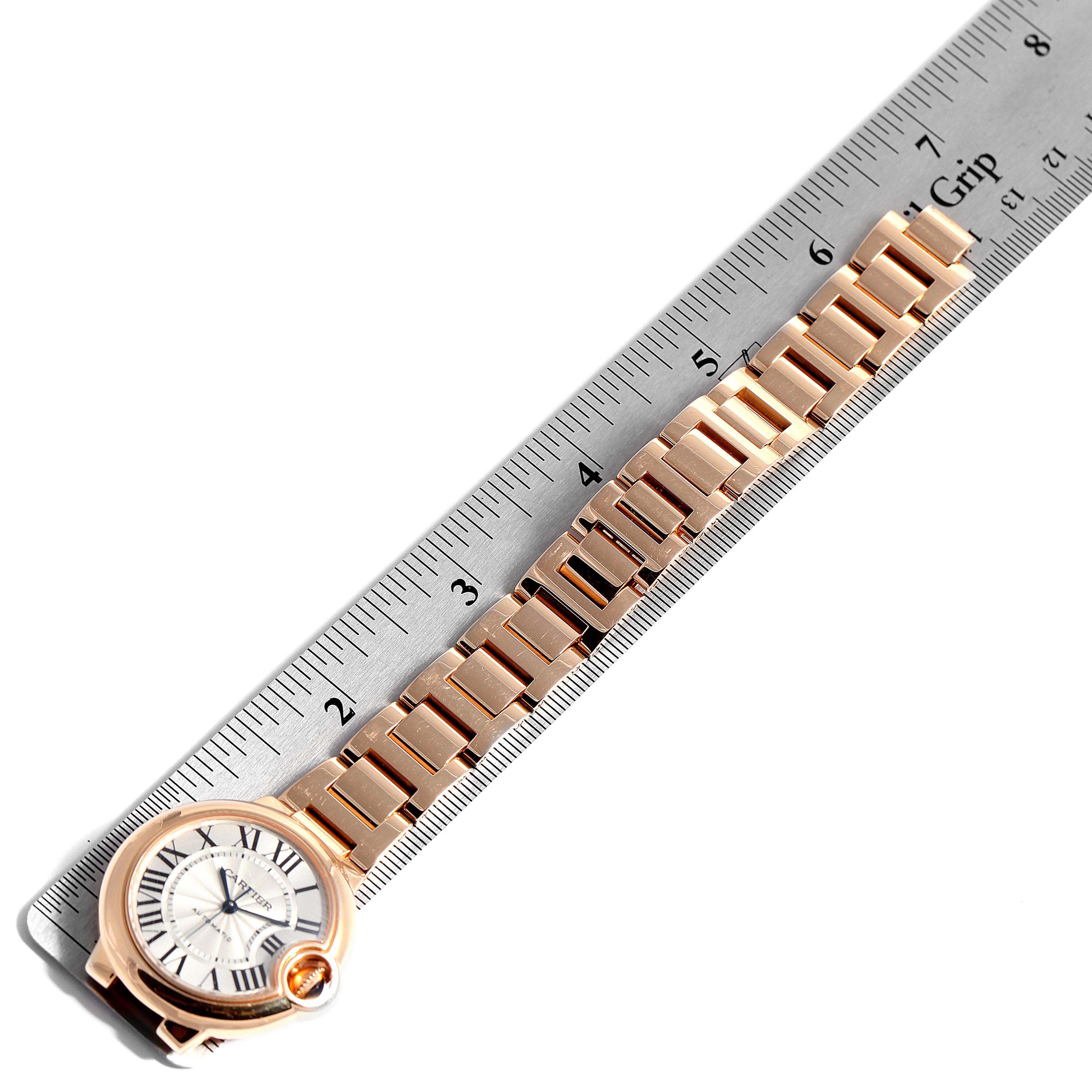 The image shows a Cartier Ballon Bleu W6920096 Women's Rose Gold Silver Dial W6920096 Women's Rose Gold Silver Dial watch laying flat with a metal ruler measuring its bracelet length.