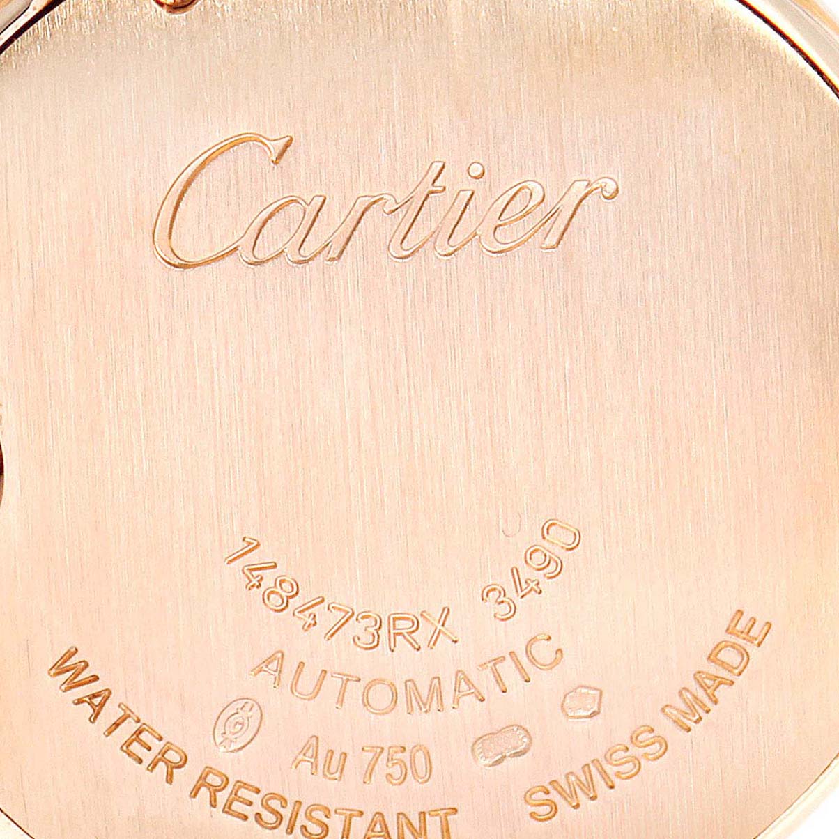 This image shows a close-up of the back case of a Cartier Ballon Bleu W6920096 Women's Rose Gold Silver Dial W6920096 Women's Rose Gold Silver Dial watch, detailing inscriptions like "Cartier," "Automatic," and "Water Resistant."
