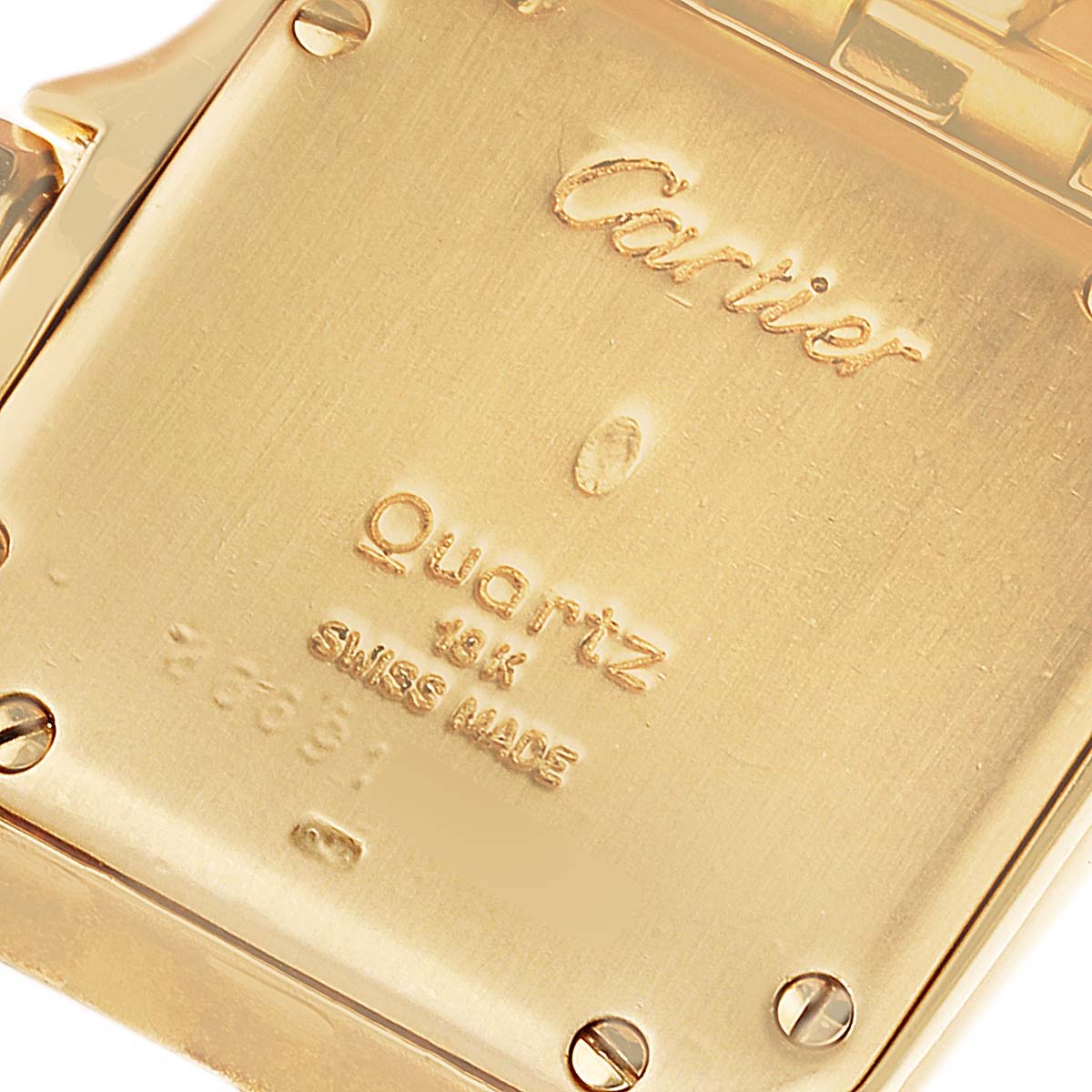 The image shows a close-up of the back case of a Cartier Panthere Women's Yellow Gold Silver Dial Women's Yellow Gold Silver Dial quartz watch, detailing text and screws.