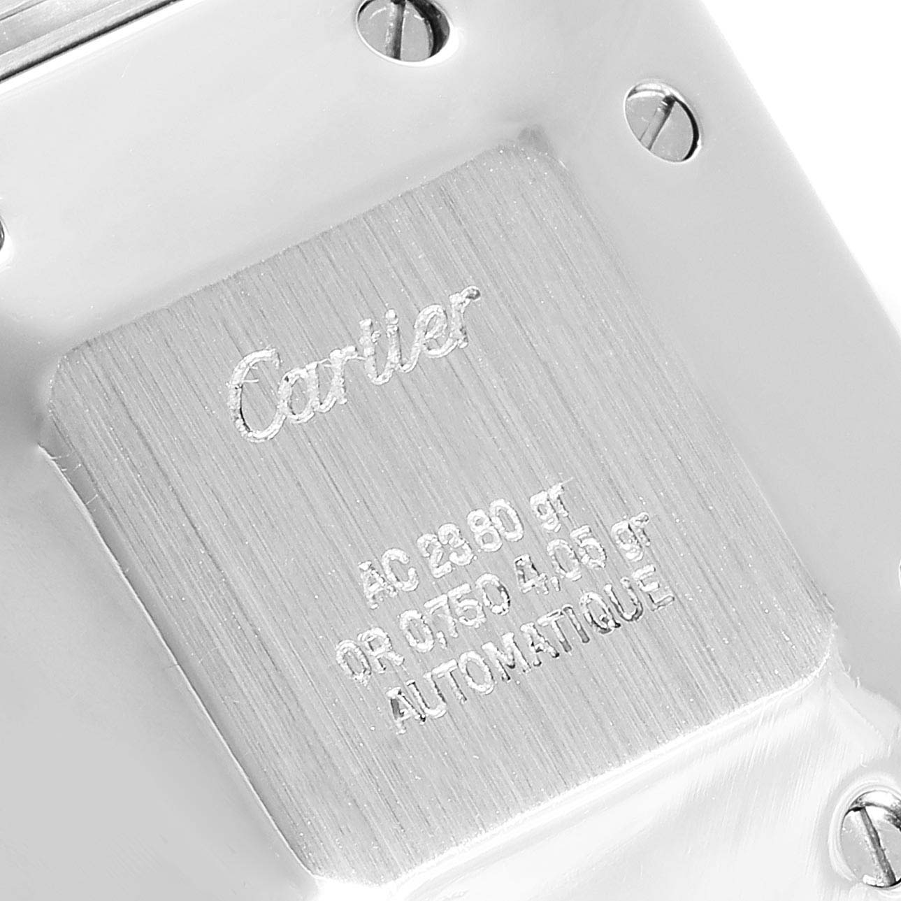 The image shows the back case of a Santos model watch by Cartier, displaying engraved details and screws.