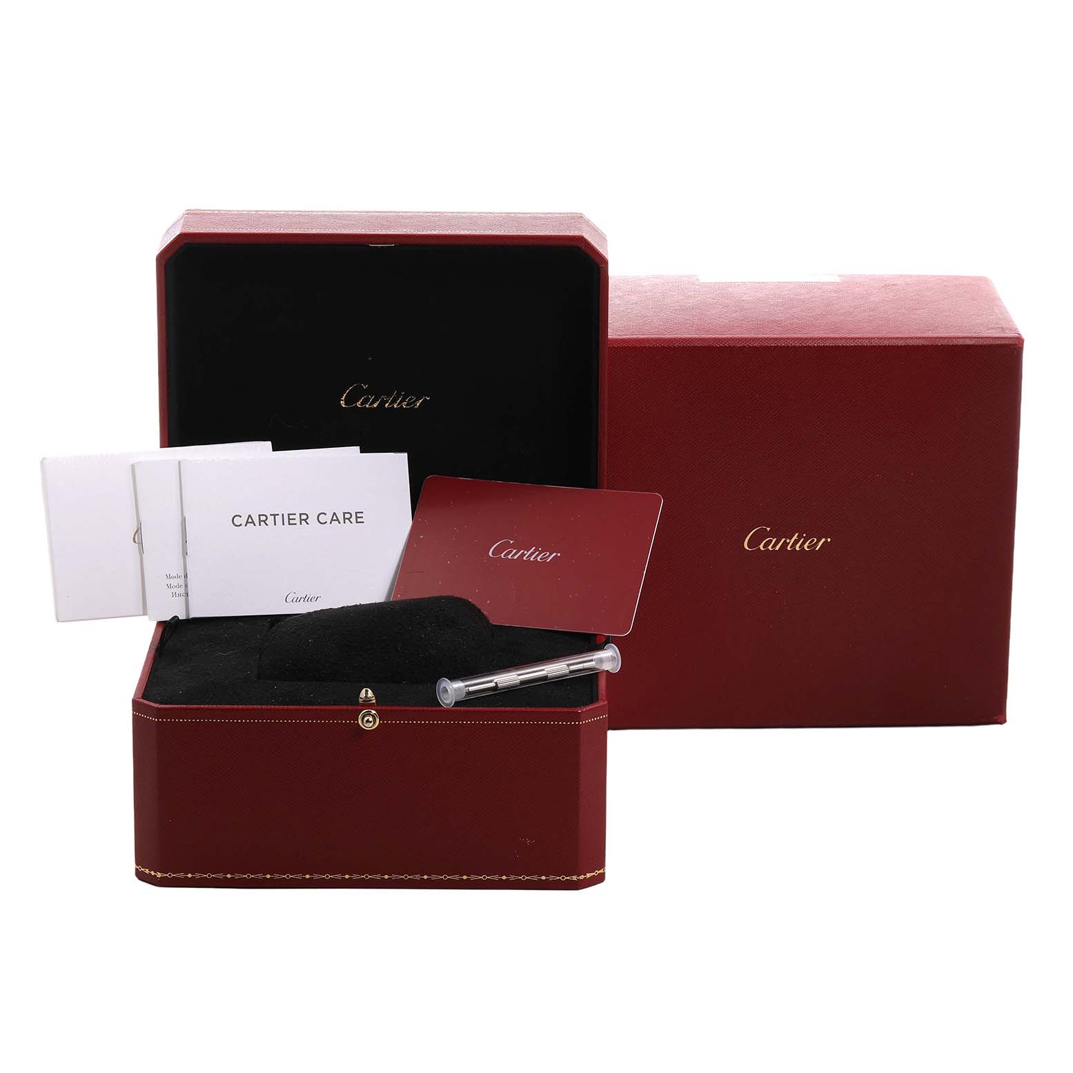 The image shows a Santos by Cartier watch box with booklets, a card, and a syringe tool on display.