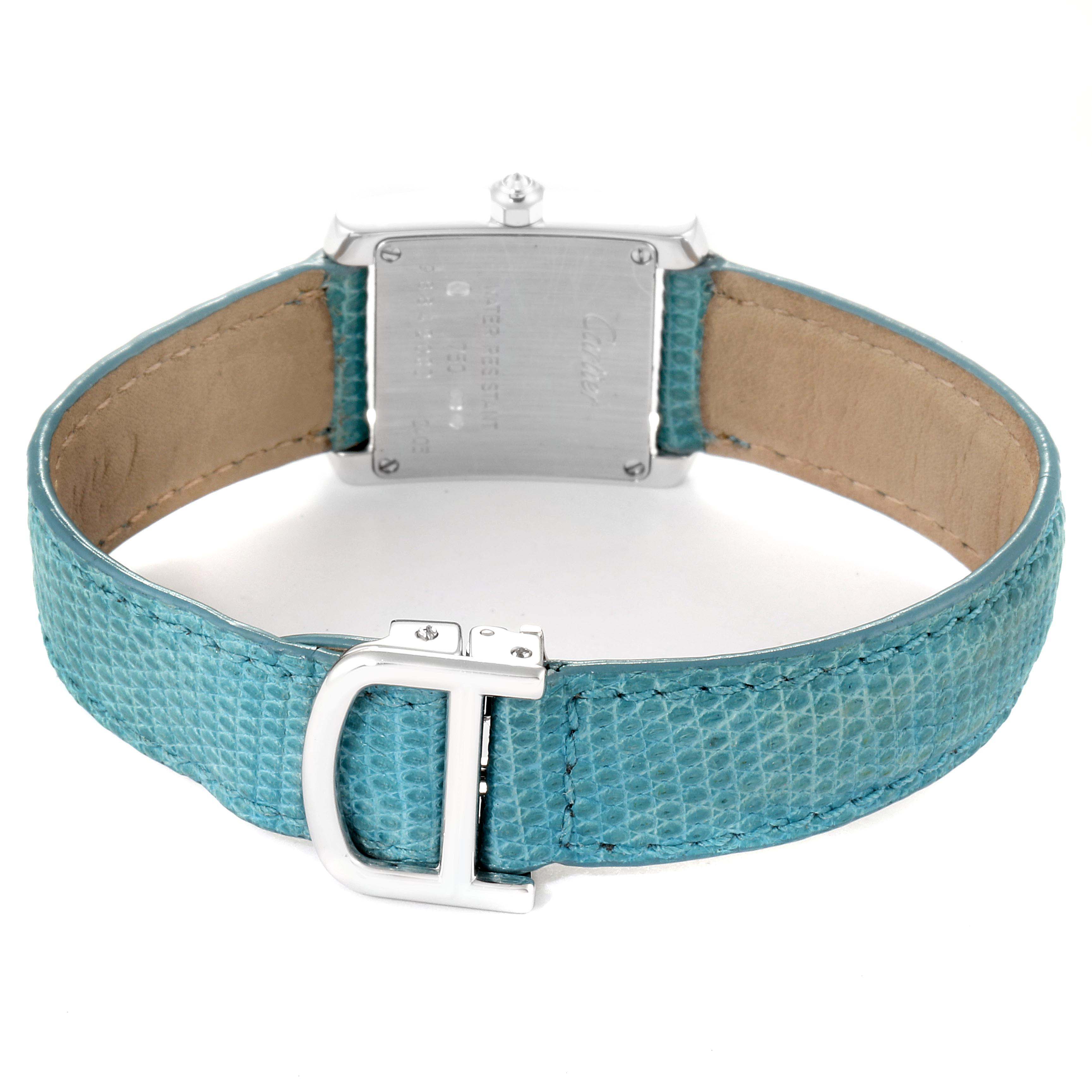 The image shows the back of a Cartier Tank Francaise WE100231 Women
s White Gold Silver Dial WE100231 Women
s White Gold Silver Dial watch, including the case back and the turquoise strap with a buckle.