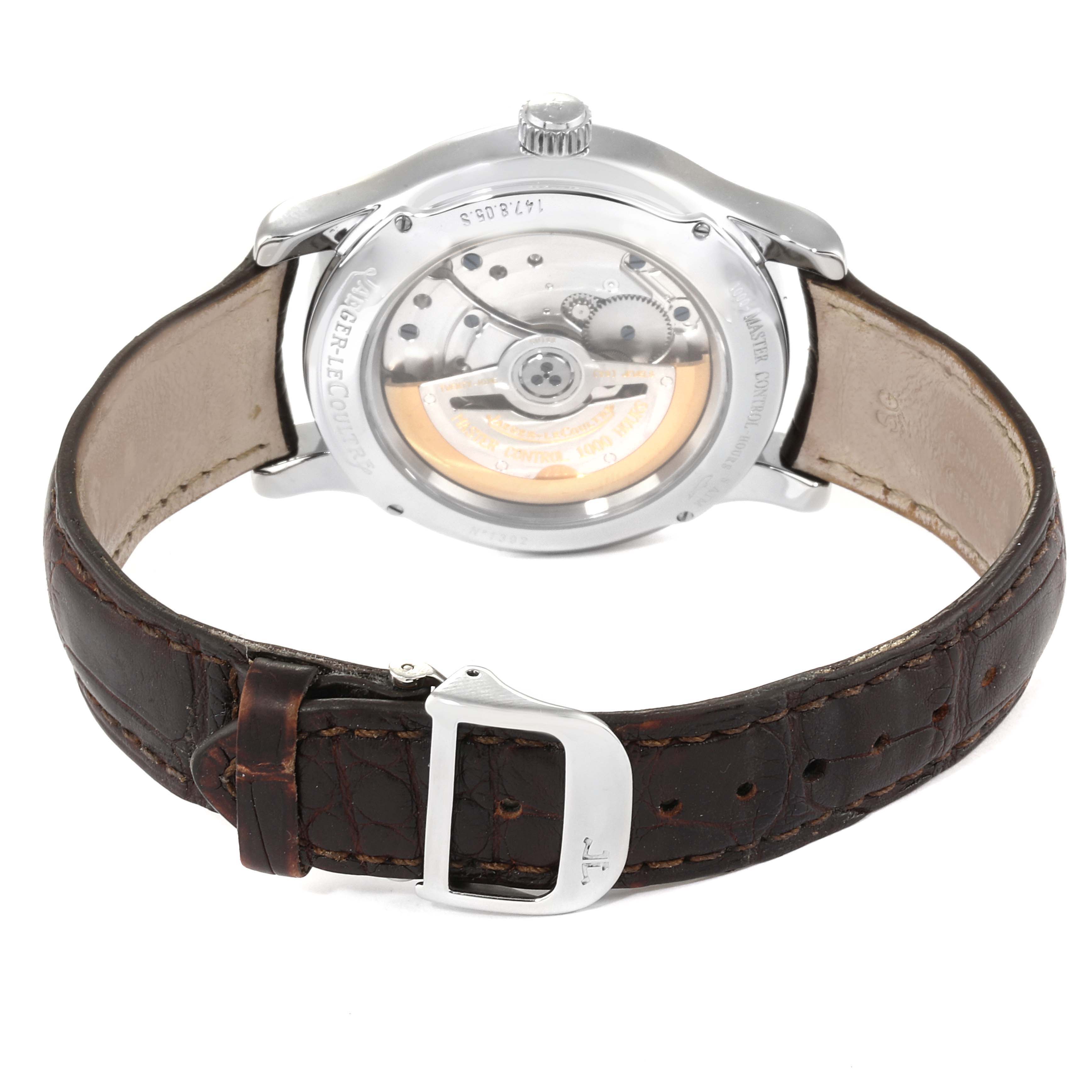 The image shows the back and movement of a Jaeger-LeCoultre Master model watch with a brown leather strap.