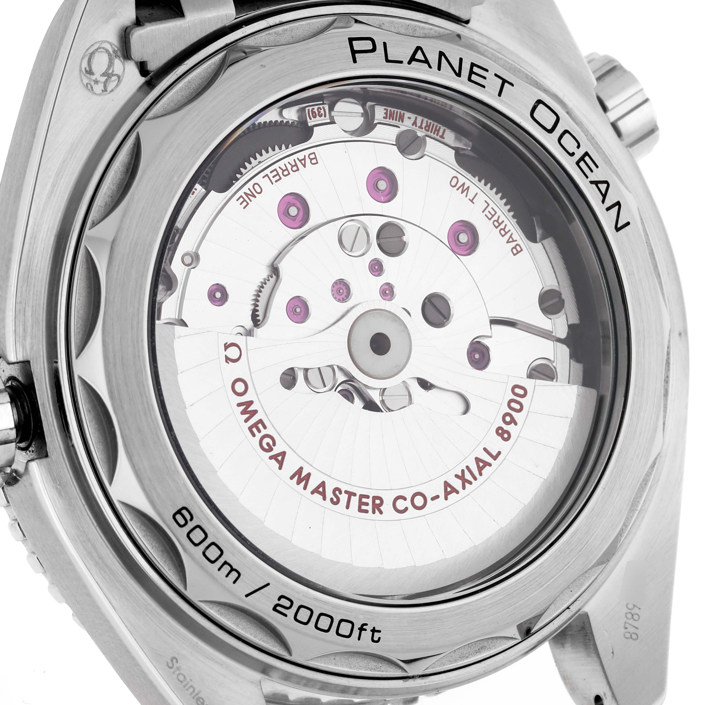 The image shows the back of an Omega Planet Ocean 215.30.44.21.01.002 Men
s Stainless Steel Black Dial 215.30.44.21.01.002 Men
s Stainless Steel Black Dial watch, revealing the automatic movement and engravings on the case.