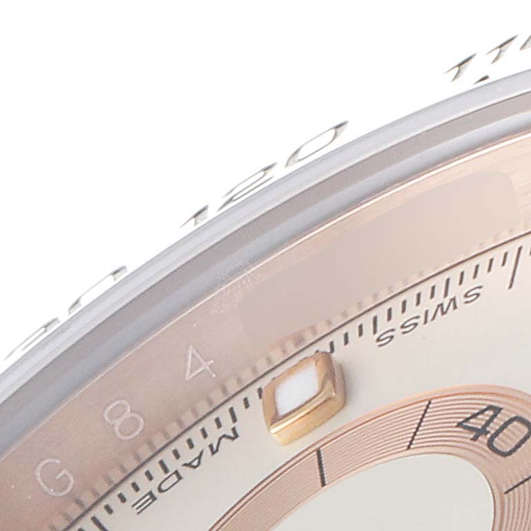 The image shows a close-up of the bezel and dial of a Rolex Daytona 116505 Men's Rose Gold Silver Dial 116505 Men's Rose Gold Silver Dial watch, highlighting the minute markers and part of the sub-dial.