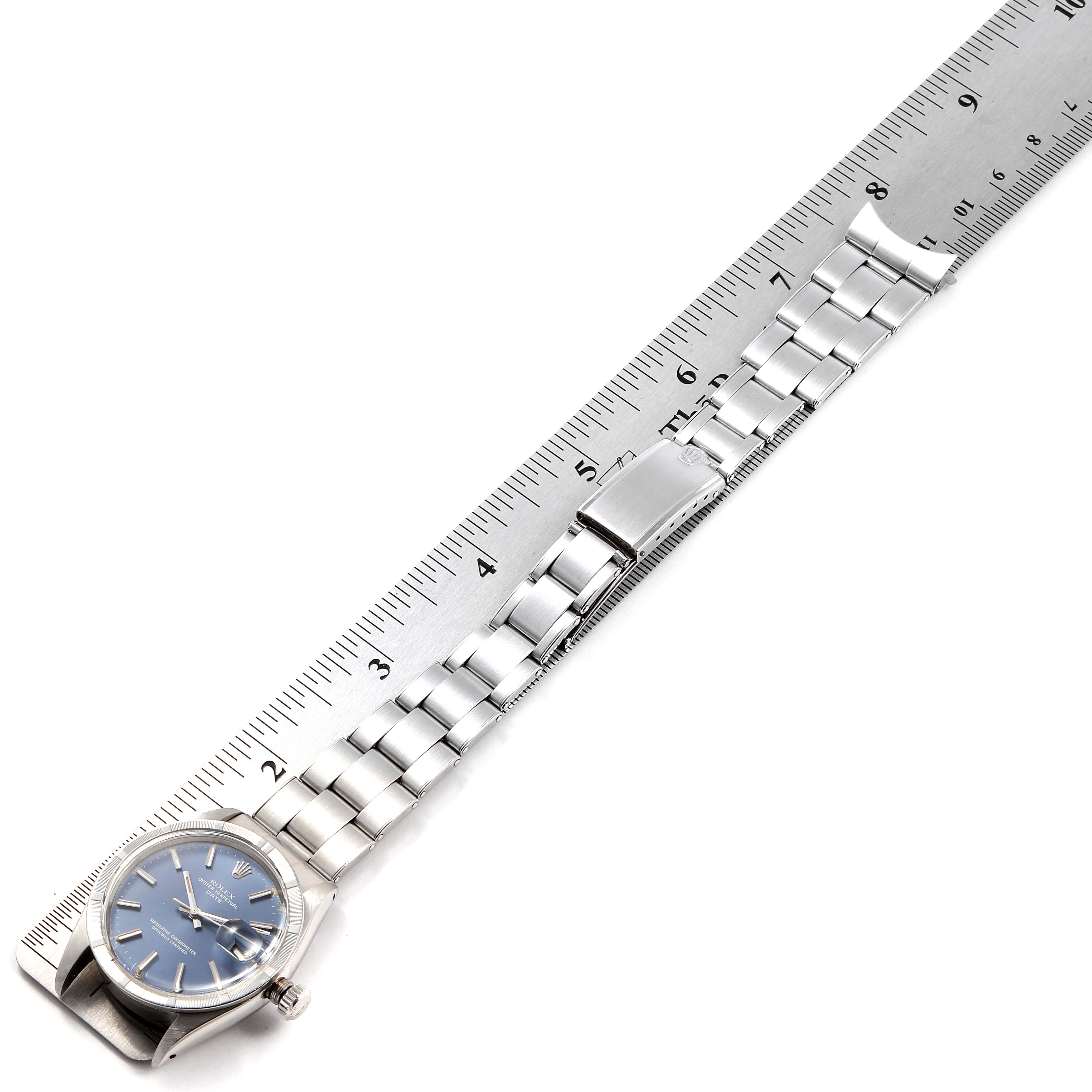 The image shows the Rolex Vintage Collection 1501 Men
s Stainless Steel Blue Dial 1501 Men
s Stainless Steel Blue Dial model watch face and full bracelet, laid next to a ruler for size reference.