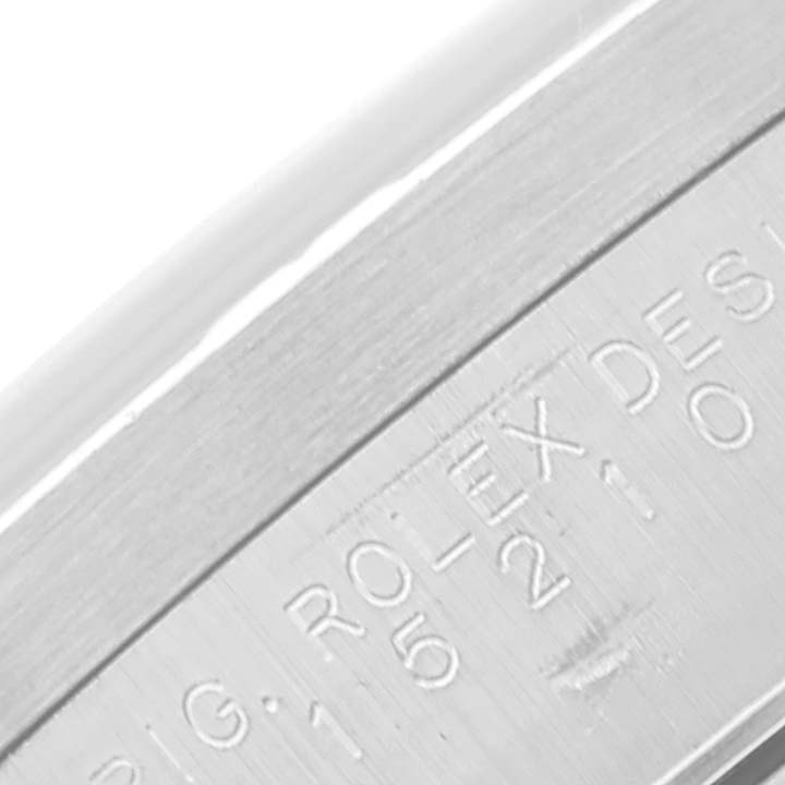 The image shows an angled close-up of the engraved side of the Rolex Date 15210 Men's Stainless Steel Silver Dial 15210 Men's Stainless Steel Silver Dial model watch case.