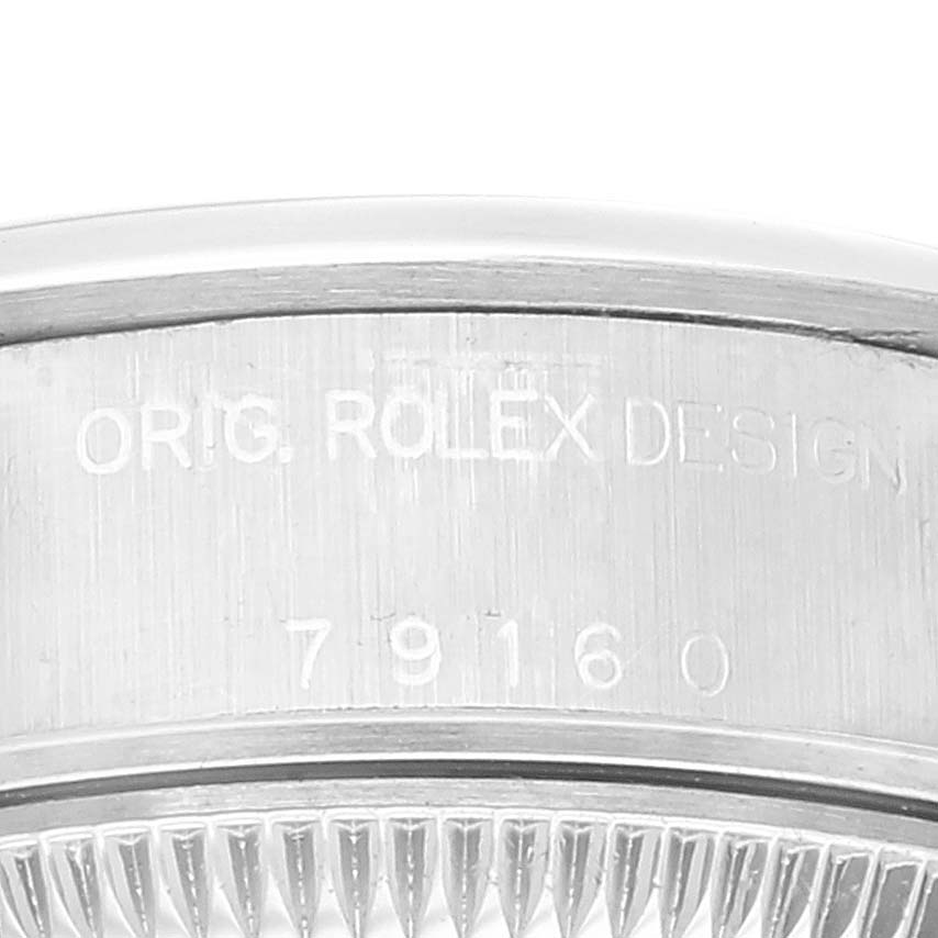 This close-up image shows the engraved serial number and "ORIG. ROLEX DESIGN" on the case of a Rolex Date 79160 Women
s Stainless Steel White Dial 79160 Women
s Stainless Steel White Dial watch.