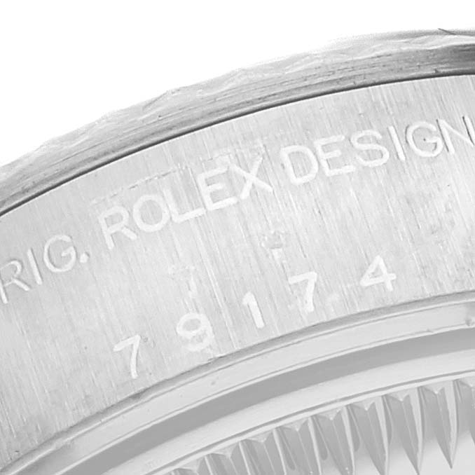 This image shows a close-up of the side of a Rolex Datejust 79174 Women's Stainless Steel Silver Dial 79174 Women's Stainless Steel Silver Dial watch, highlighting the engraved model and brand name on the case.