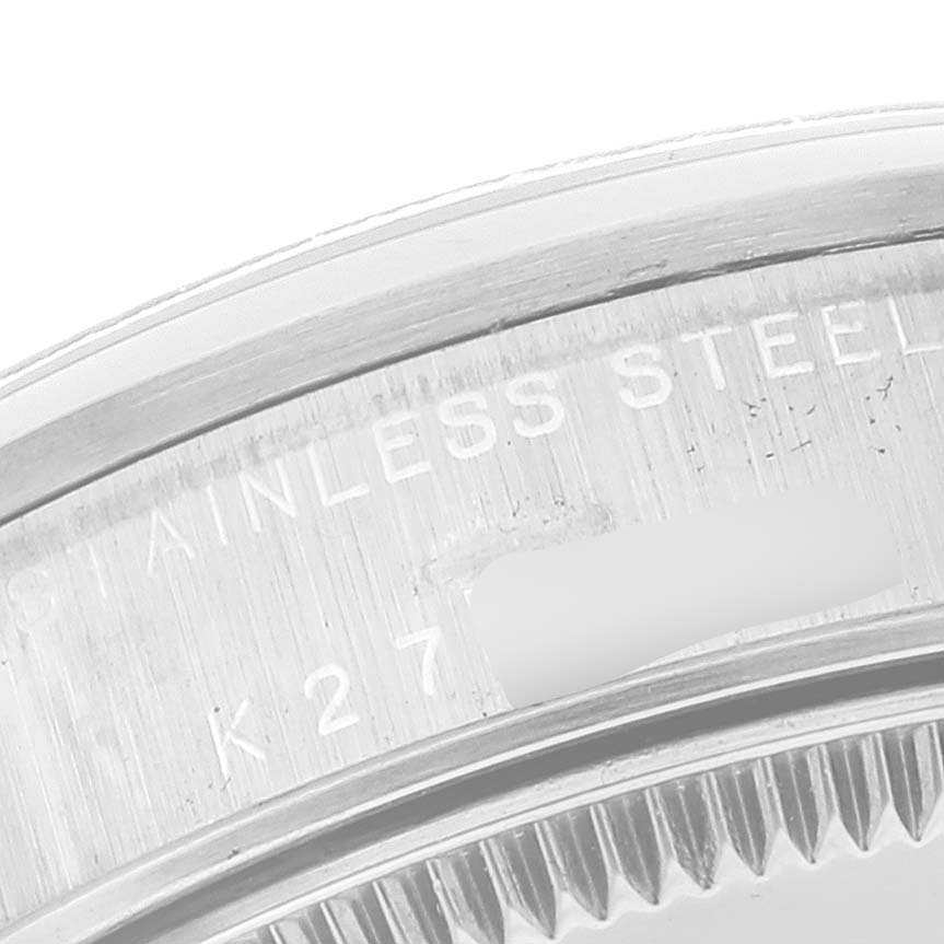 The image shows a close-up of the stainless steel case back with engraved text of a Rolex Mid-Size 78240 Women's Stainless Steel Black Dial 78240 Women's Stainless Steel Black Dial model watch.