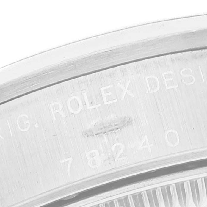 This close-up image features the engraved text on the caseback of a Mid-Size Rolex watch, showing part of the model number.