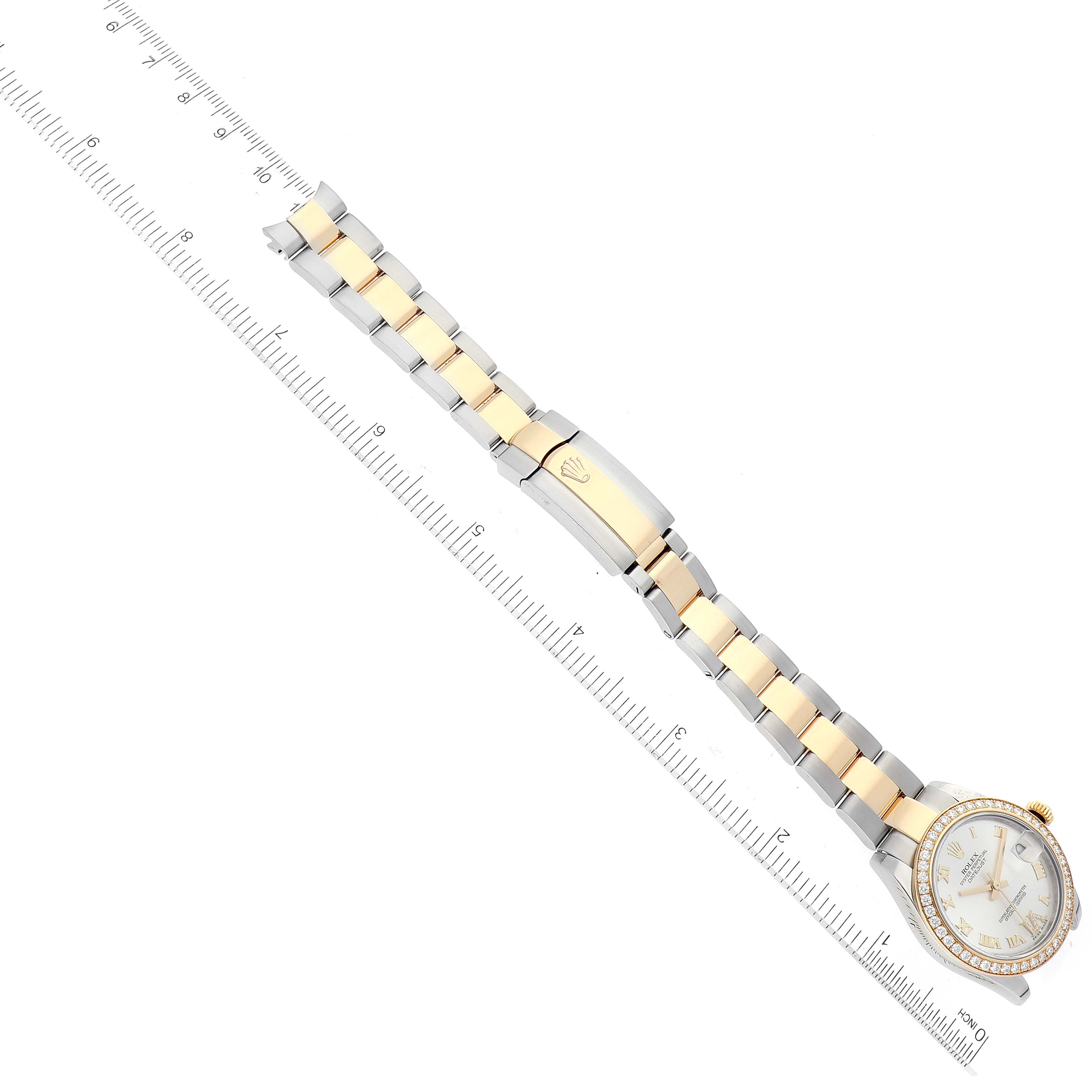 This image shows an aerial view of a Mid-Size Rolex watch, highlighting its face, bezel, and bi-metal bracelet alongside a ruler.
