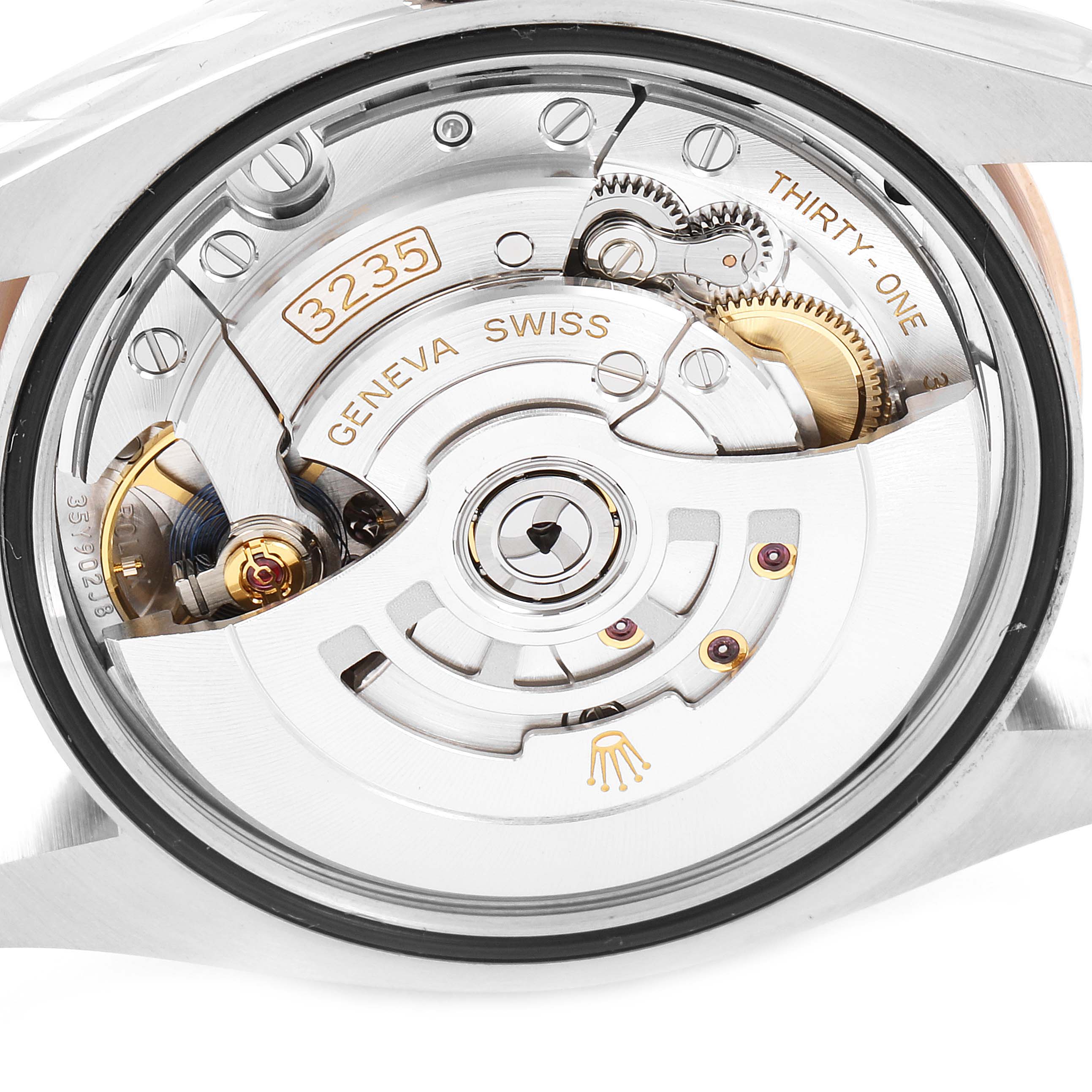 The image shows the movement mechanism of a Rolex Datejust 126201 Men's Steel and Gold (two tone) Brown Dial 126201 Men's Steel and Gold (two tone) Brown Dial watch from a rear angle, highlighting its intricate inner workings.
