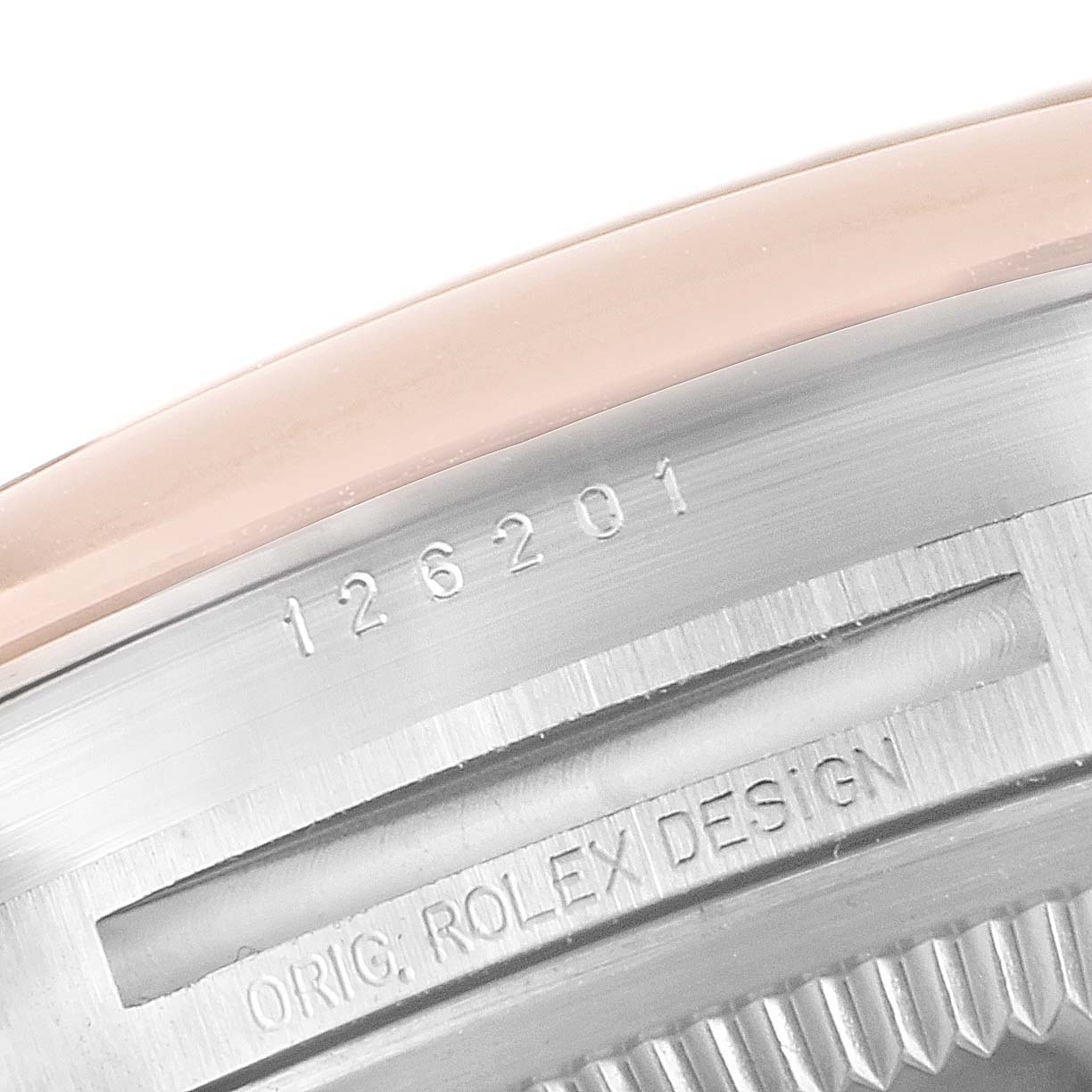 This image shows a close-up of the engraving on the side of the case for the Rolex Datejust 126201 Men's Steel and Gold (two tone) Brown Dial 126201 Men's Steel and Gold (two tone) Brown Dial model.