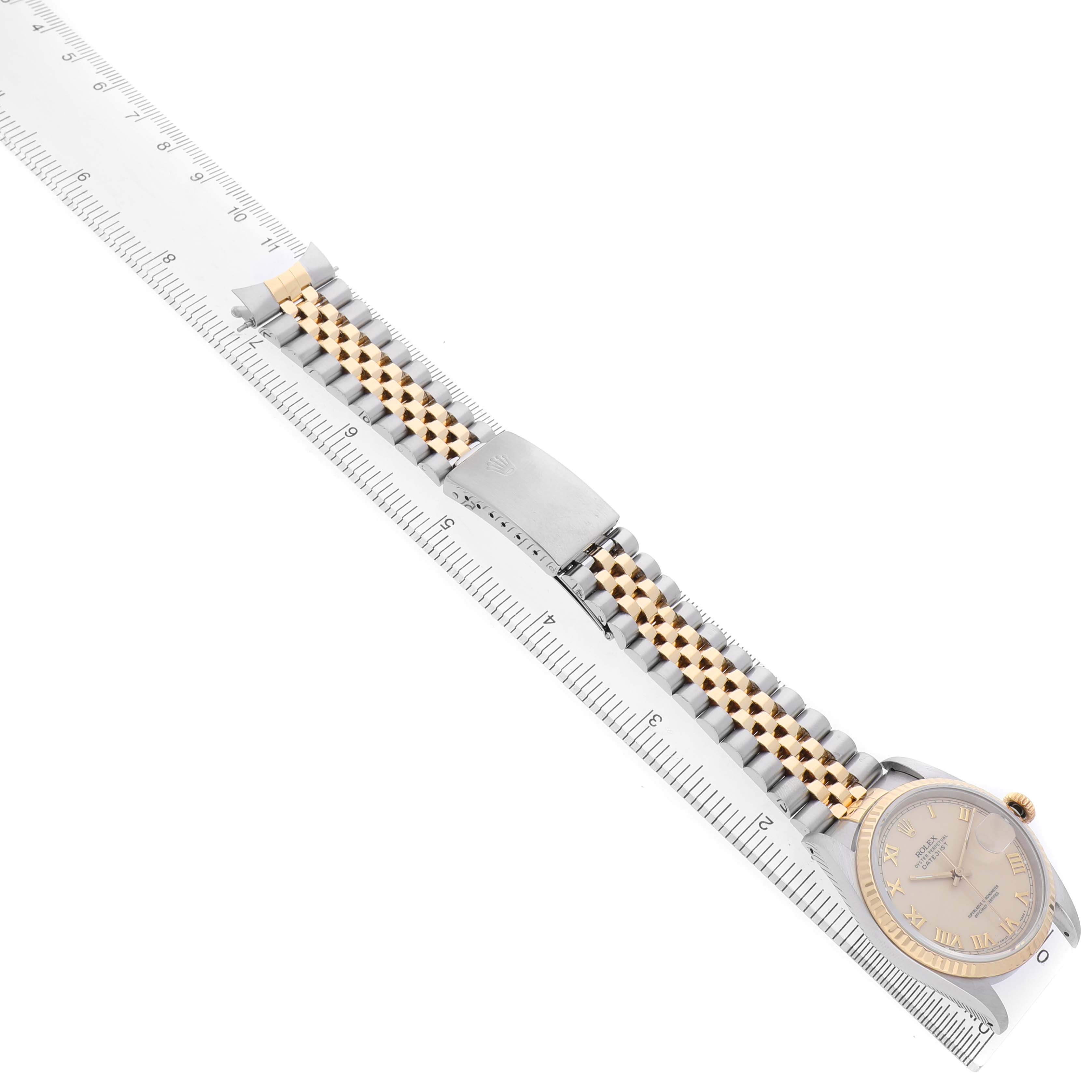 The image shows the side view of a Rolex Datejust 16233 Men's Steel and Gold (two tone) White Dial watch with a two-tone bracelet and a ruler for measurement.