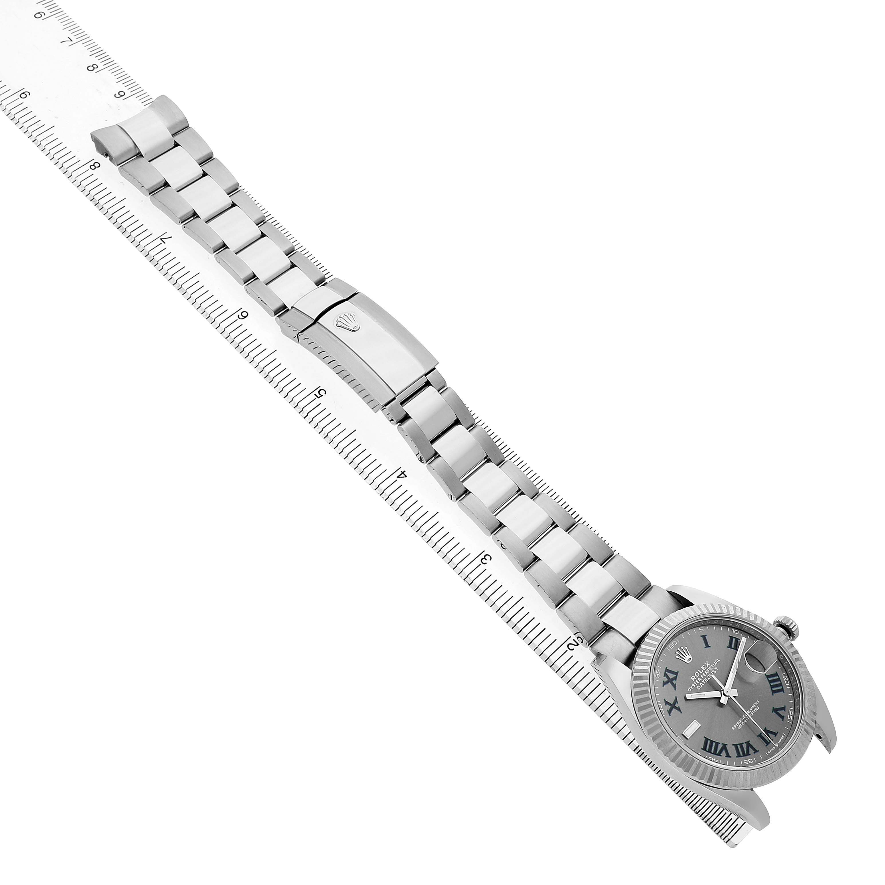 The Rolex Datejust 41 126334 Men's Stainless Steel Grey Dial watch is shown at an angled view, highlighting the bracelet, clasp, and face alongside a ruler.