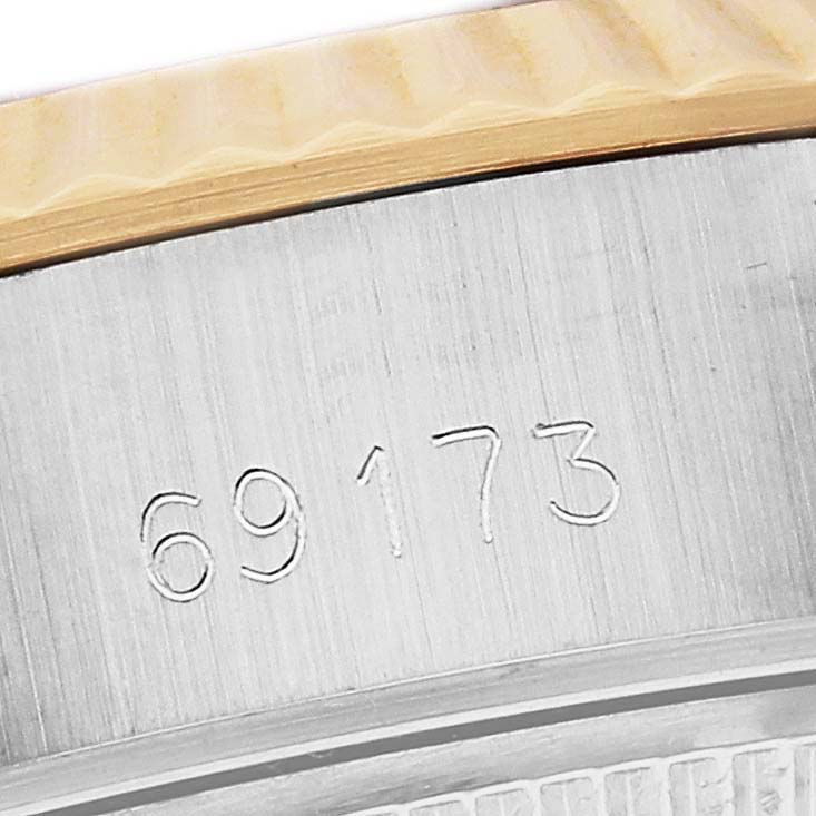 This image shows a close-up of the case of a Rolex Datejust 69173 Women's Steel and Gold (two tone) Champagne Dial 69173 Women's Steel and Gold (two tone) Champagne Dial, focusing on the engraved serial number "69173."