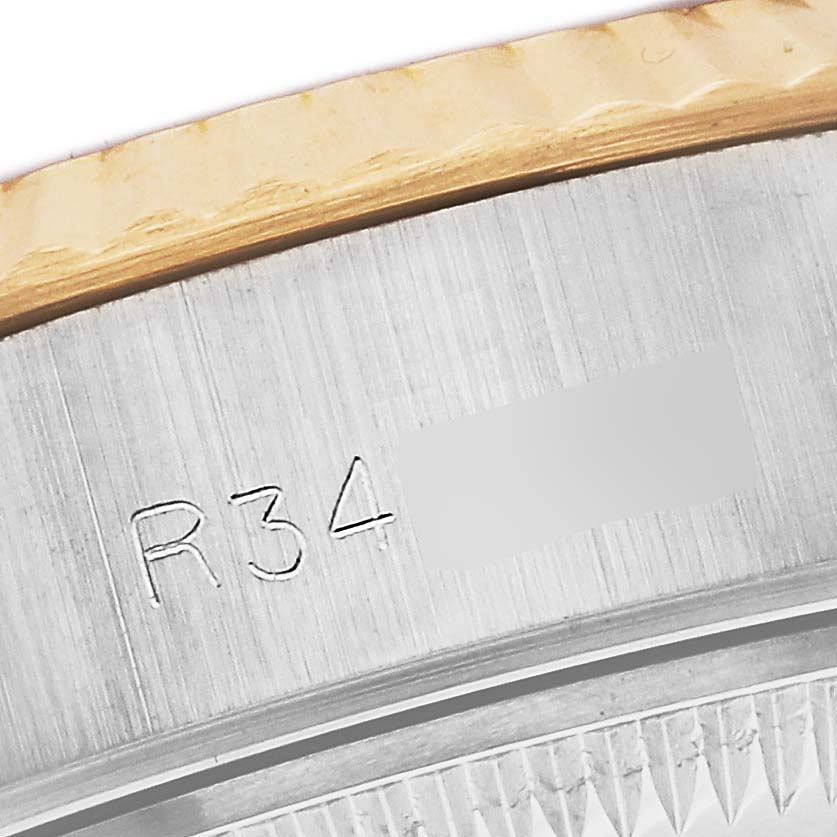 This image shows a close-up of the case with engraved serial numbers of a Rolex Datejust 69173 Women's Steel and Gold (two tone) Champagne Dial 69173 Women's Steel and Gold (two tone) Champagne Dial watch.