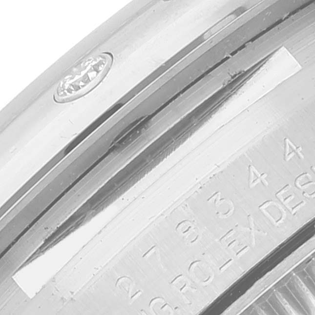 This close-up image shows the serial number inscribed on the side of a Rolex Mid-Size 278344 Women's Stainless Steel Purple Dial 278344 Women's Stainless Steel Purple Dial watch case.