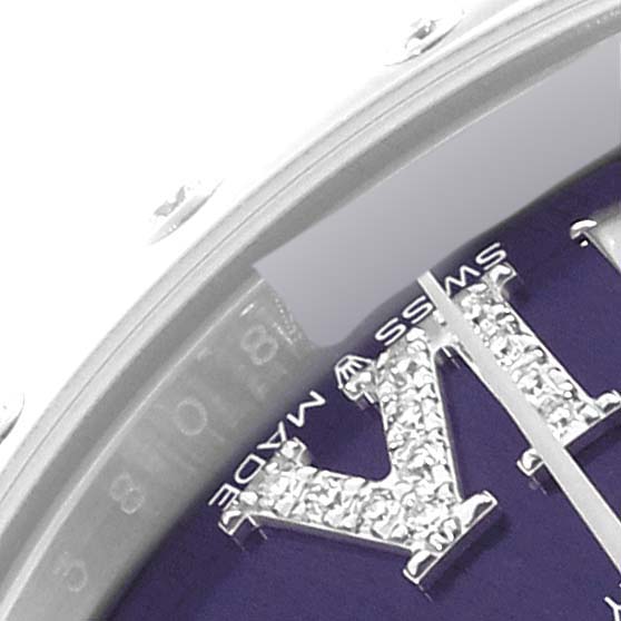 This close-up shot of the Rolex Mid-Size 278344 Women's Stainless Steel Purple Dial 278344 Women's Stainless Steel Purple Dial model shows the jeweled "X" on the dial and part of the chapter ring.