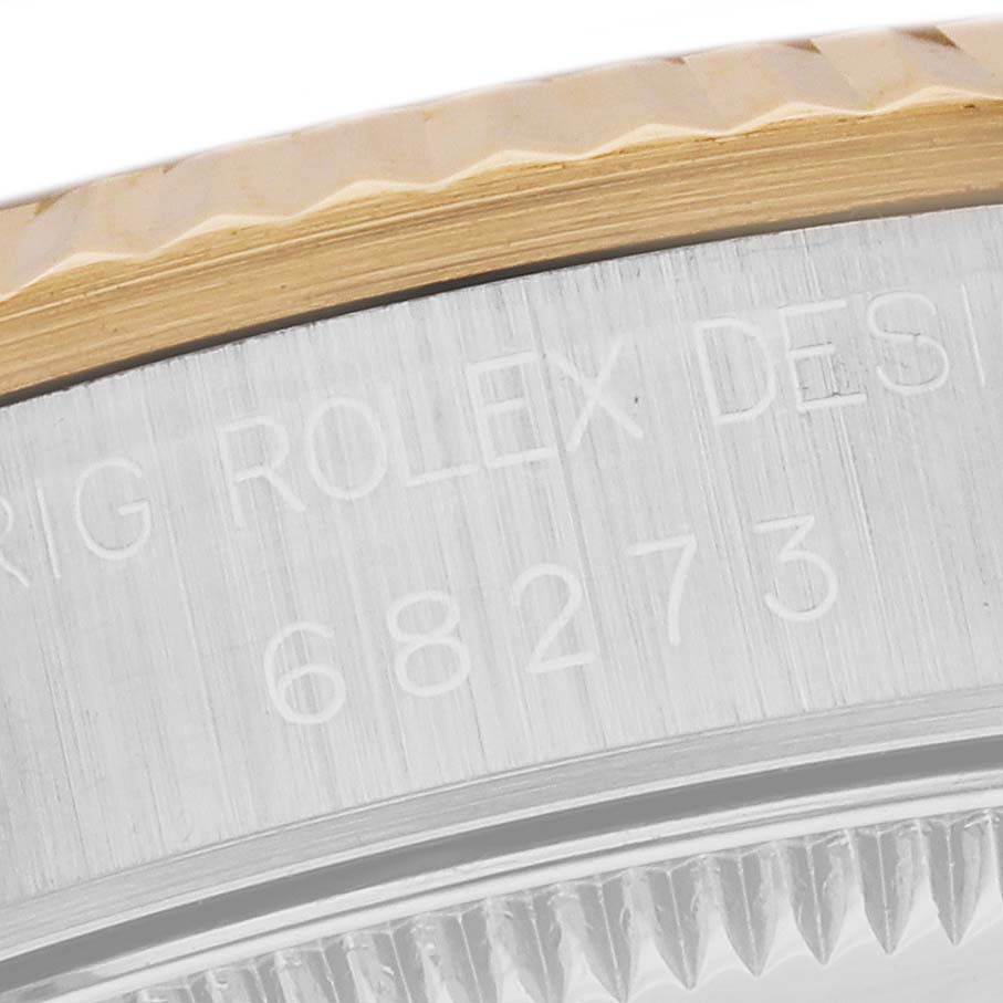 This image shows a close-up of the side of the case and the fluted bezel of a Mid-Size Rolex 68273 watch.