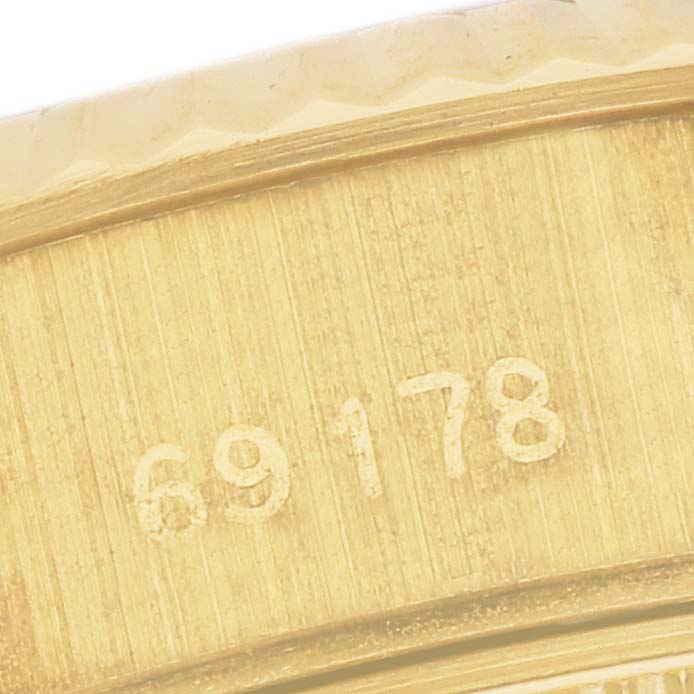 This close-up image shows the serial number engraved on the side of a Rolex President 69178 Women's Yellow Gold White Dial 69178 Women's Yellow Gold White Dial model watch bezel.