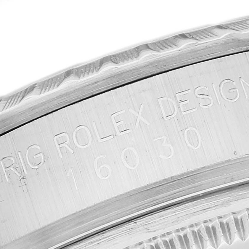 This close-up image shows the serial number and design engraving on the case back of a Vintage Collection Rolex watch.