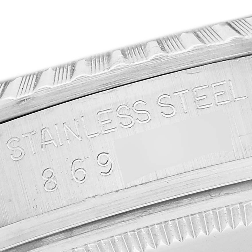 This close-up image shows the engraved stainless steel marking and partial serial number on the case of a Vintage Collection model by Rolex.