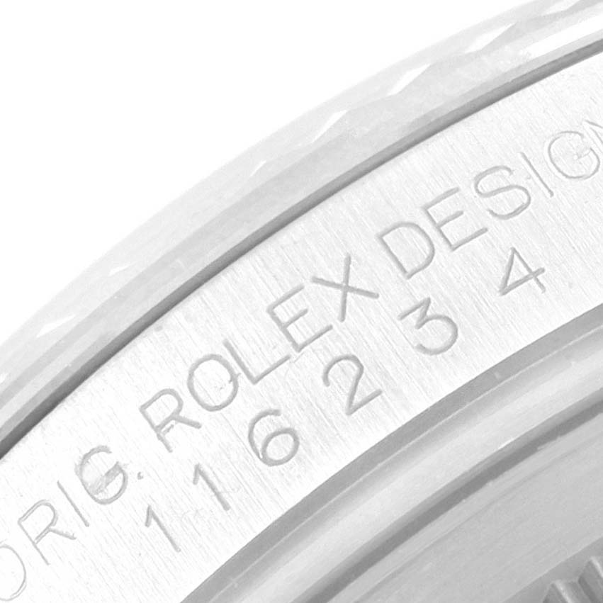 The image shows a close-up of the engraved side of the bezel on a Rolex Datejust 116234 Men
s Stainless Steel Black Dial 116234 Men
s Stainless Steel Black Dial watch.