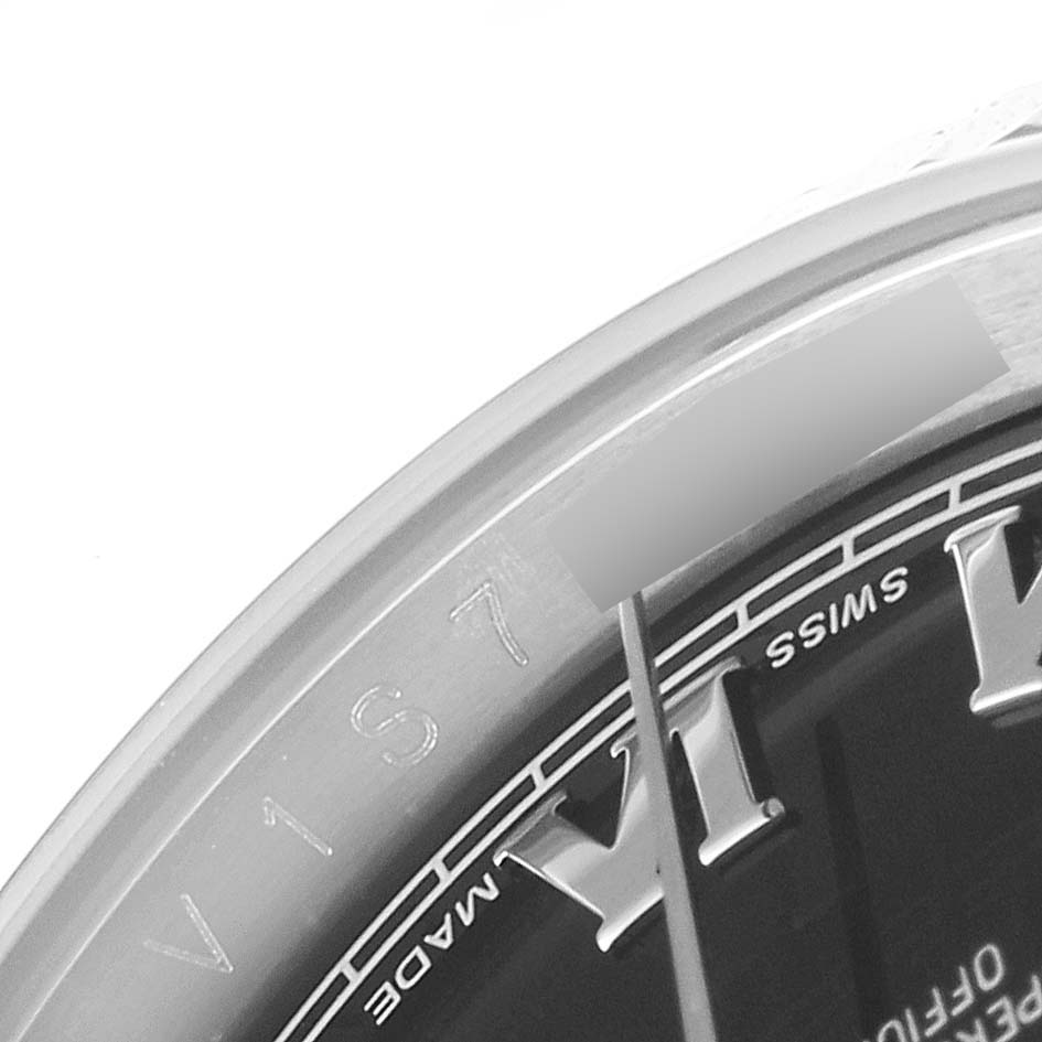 This close-up image of a Rolex Datejust 116234 Men
s Stainless Steel Black Dial 116234 Men
s Stainless Steel Black Dial watch shows part of the bezel, dial, and hour hand.