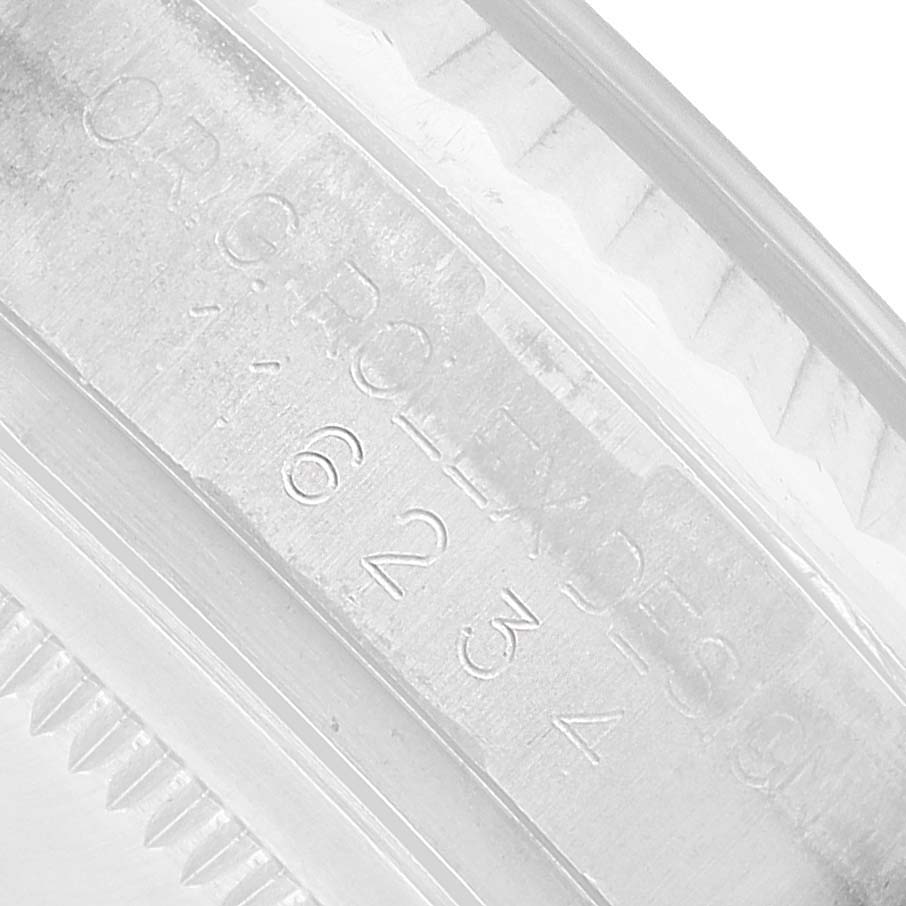 The image shows a close-up of the engraved serial number on the inner bezel of a Rolex Datejust 116234 Men's Stainless Steel Silver Dial.