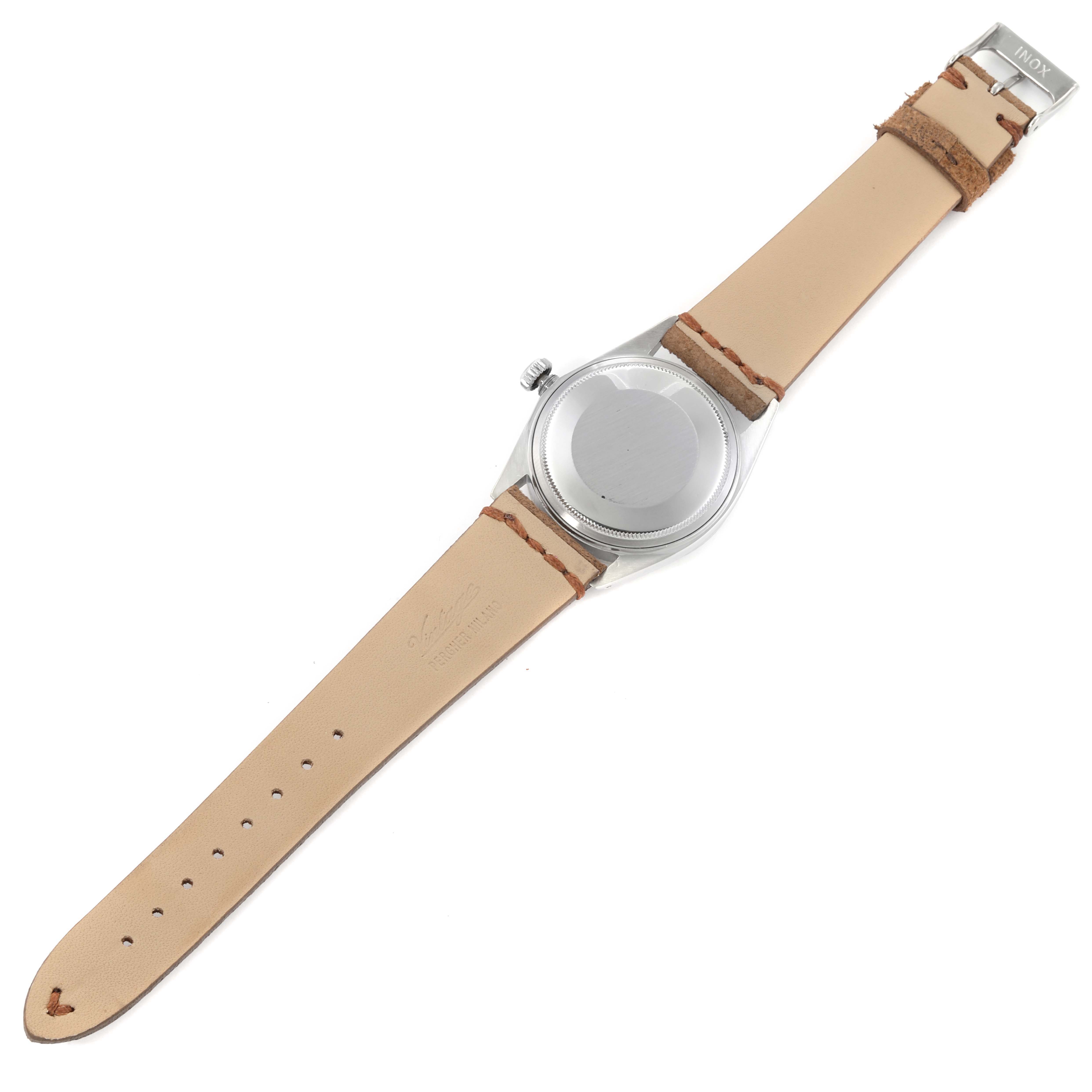 The image shows the Vintage Collection model by Rolex from the back, highlighting the leather strap and case back.