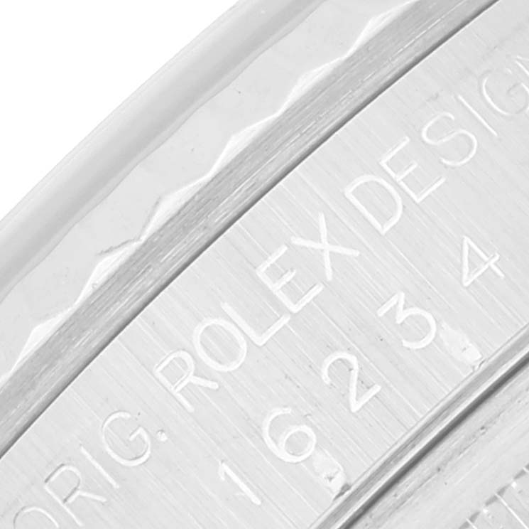 This is a close-up of the engraved bezel and case side of a Rolex Datejust 16234 Men's Stainless Steel Silver Dial 16234 Men's Stainless Steel Silver Dial watch.