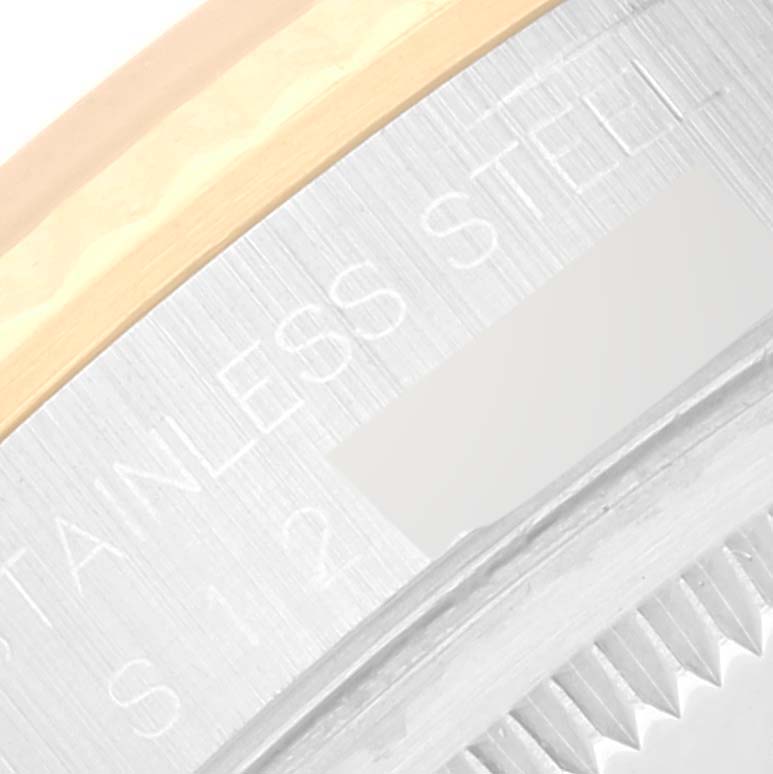 The image shows a close-up angle of the bezel and casing of a Rolex Datejust 16233 Men's Steel and Gold (two tone) Champagne Dial 16233 Men's Steel and Gold (two tone) Champagne Dial watch, focusing on the "STAINLESS STEEL" engraving.