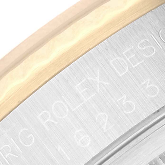 The image shows a close-up of the side view of the bezel and casing of a Rolex Datejust 16233 Men's Steel and Gold (two tone) Champagne Dial 16233 Men's Steel and Gold (two tone) Champagne Dial watch.