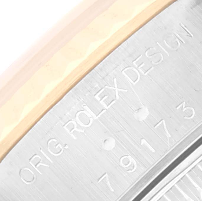 The image shows a close-up angle of the engraving on the side of the bezel of a Rolex Datejust 79173 Women's Steel and Gold (two tone) Champagne Dial 79173 Women's Steel and Gold (two tone) Champagne Dial watch.