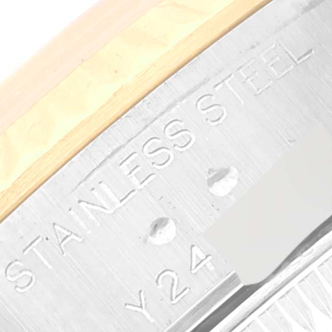 This close-up image shows the inscription "STAINLESS STEEL" along with other markings on the case back of a Rolex Datejust 79173 Women's Steel and Gold (two tone) Champagne Dial 79173 Women's Steel and Gold (two tone) Champagne Dial watch.