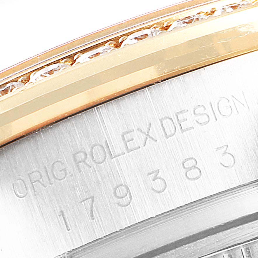 The image is a close-up of the case, bezel, and serial number engraving of a Rolex Datejust 179383 Women
s Steel and Gold (two tone) Silver Dial 179383 Women
s Steel and Gold (two tone) Silver Dial watch.