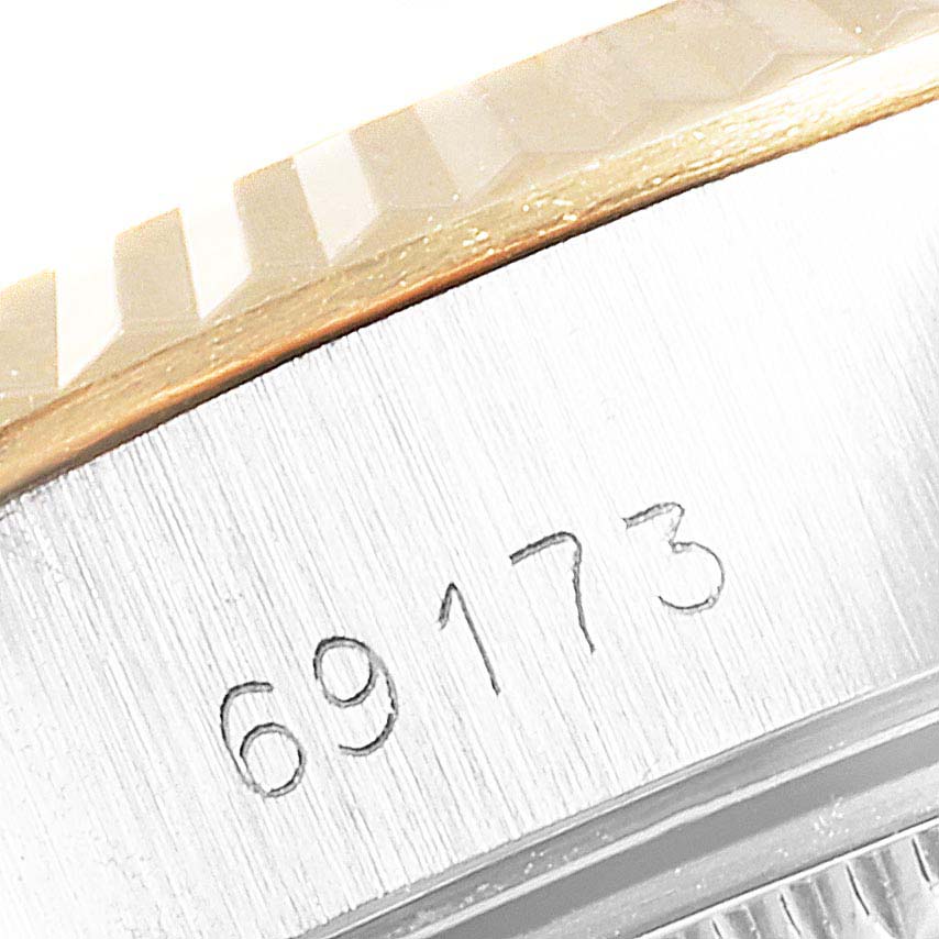 The image shows the side of a Rolex Datejust 69173 Women
s Steel and Gold (two tone) Champagne Dial 69173 Women
s Steel and Gold (two tone) Champagne Dial watch, highlighting the engraved model number "69173" beneath the bezel.