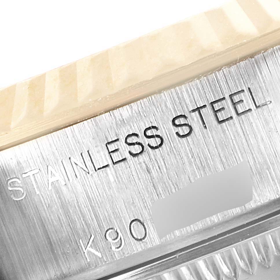 The image shows a close-up angle of the side of a Rolex Datejust 79173 Women's Steel and Gold (two tone) Mother of Pearl Dial 79173 Women's Steel and Gold (two tone) Mother of Pearl Dial, displaying the "STAINLESS STEEL" engraving.