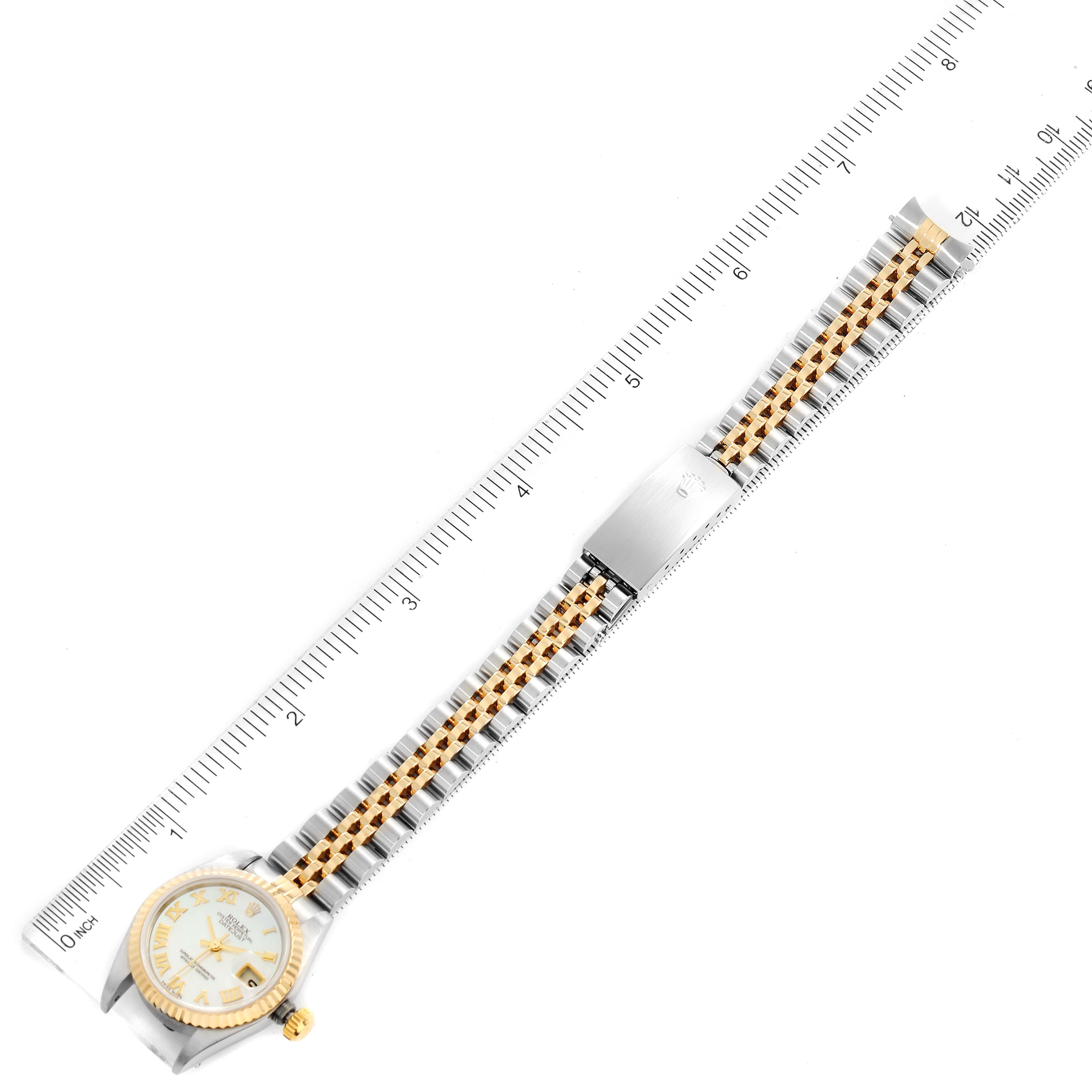 The Rolex Datejust 79173 Women's Steel and Gold (two tone) Mother of Pearl Dial 79173 Women's Steel and Gold (two tone) Mother of Pearl Dial watch is shown flat with the face and bracelet fully extended, measured with a ruler.