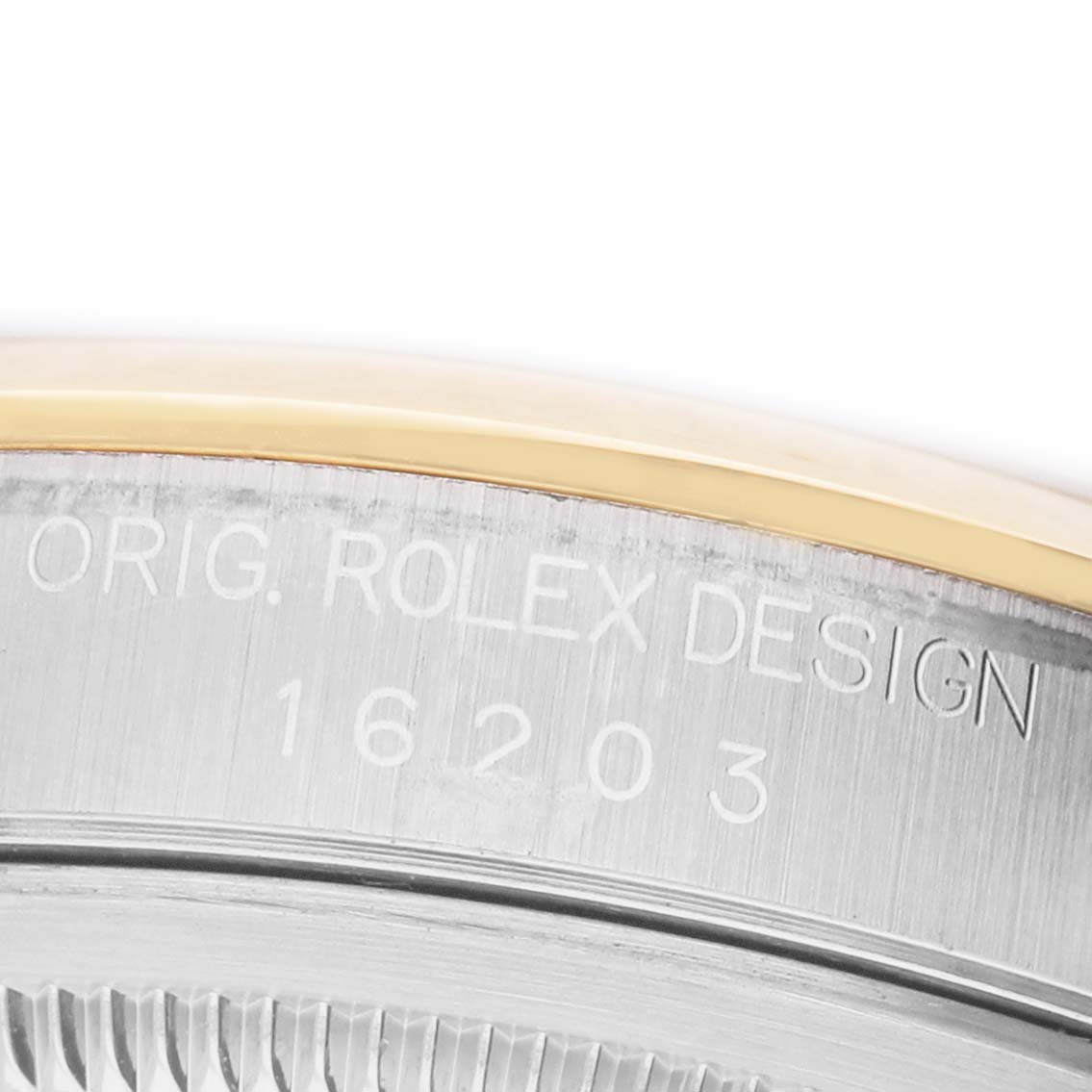 The image shows a close-up angle of the engraved side of a Rolex Datejust 16203 Men's Steel and Gold (two tone) Silver Dial watch.