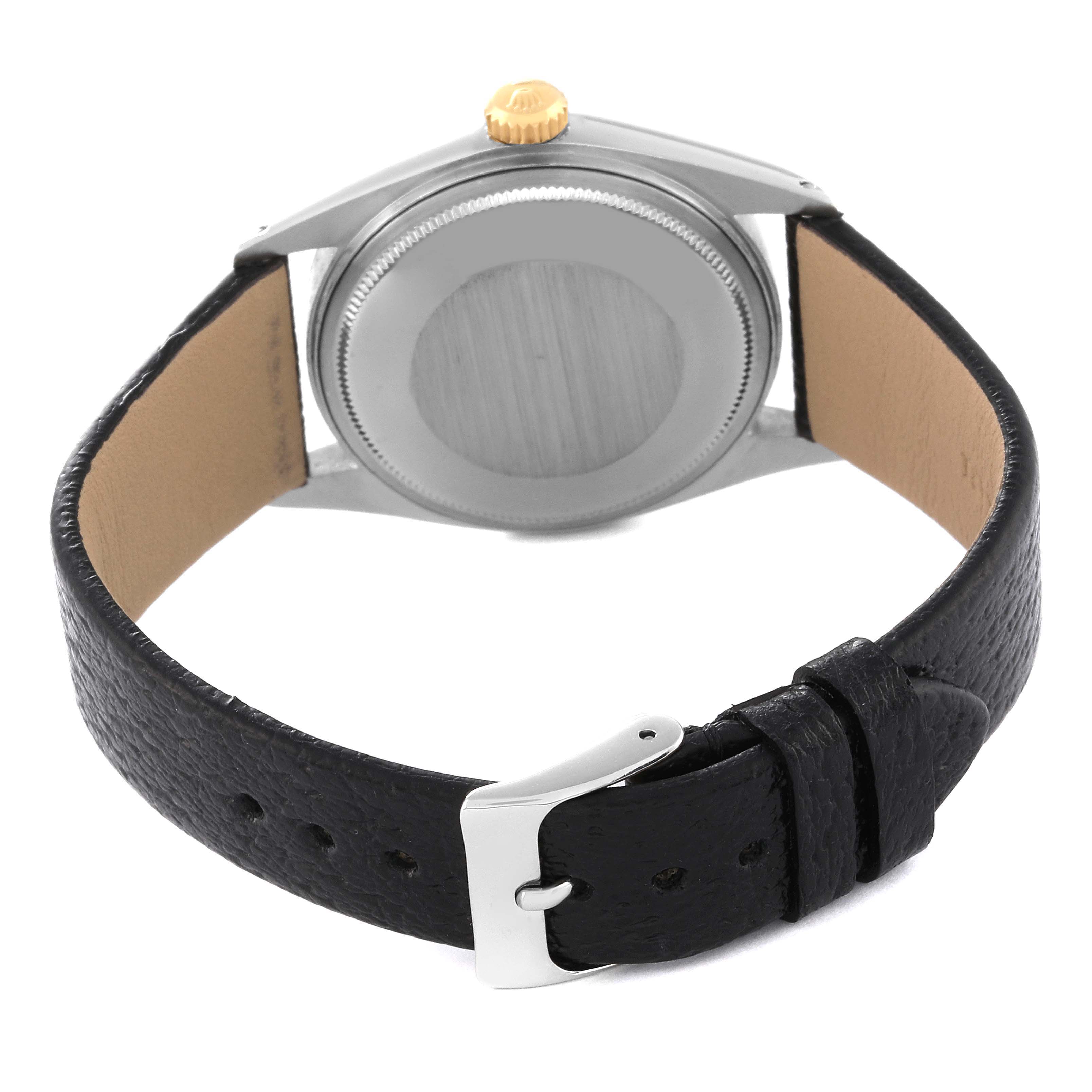 The image shows the back view of a Rolex Vintage Collection 1601 Men's Steel and Gold (two tone) Silver Dial 1601 Men's Steel and Gold (two tone) Silver Dial watch with a leather strap and metal clasp.