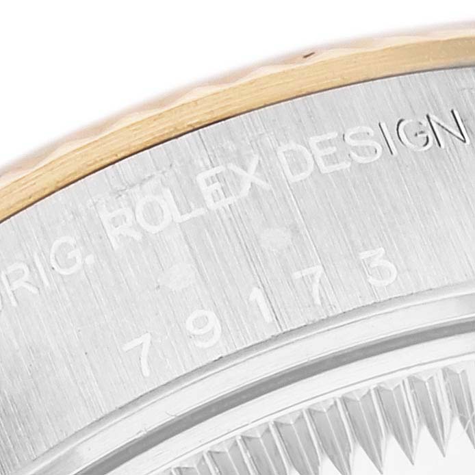 This image shows a close-up of the engraved bezel on a Rolex Datejust 79173 Women's Steel and Gold (two tone) Grey Dial 79173 Women's Steel and Gold (two tone) Grey Dial watch.