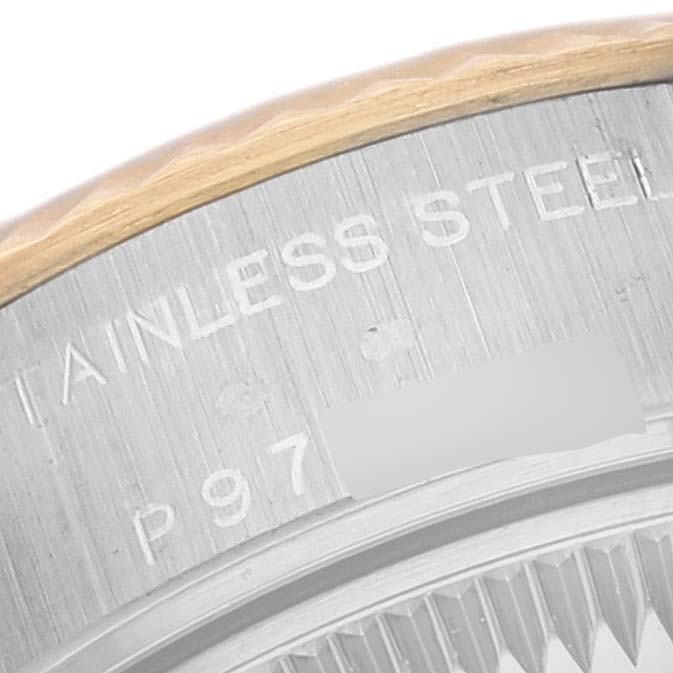 This close-up view shows the edge of the bezel and part of the case back of a Rolex Datejust 79173 Women's Steel and Gold (two tone) Grey Dial 79173 Women's Steel and Gold (two tone) Grey Dial watch.