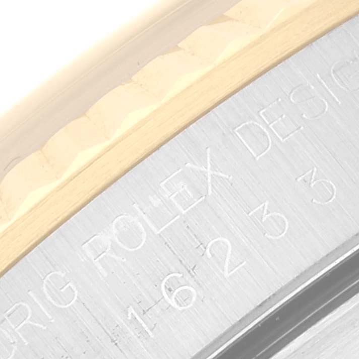 This close-up image shows the bezel and engraved side of a Rolex Datejust 16233 Men's Steel and Gold (two tone) Grey Dial 16233 Men's Steel and Gold (two tone) Grey Dial watch.
