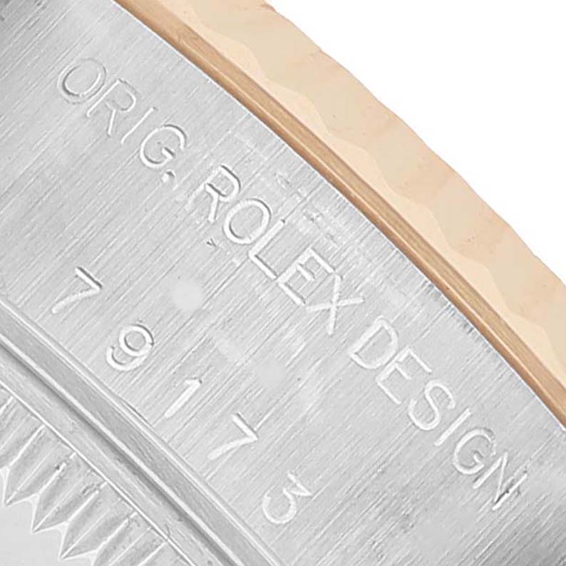 The image shows a close-up of the Rolex Datejust 79173 Women's Stainless Steel White Dial model's case side, highlighting the engraved model number and design text.